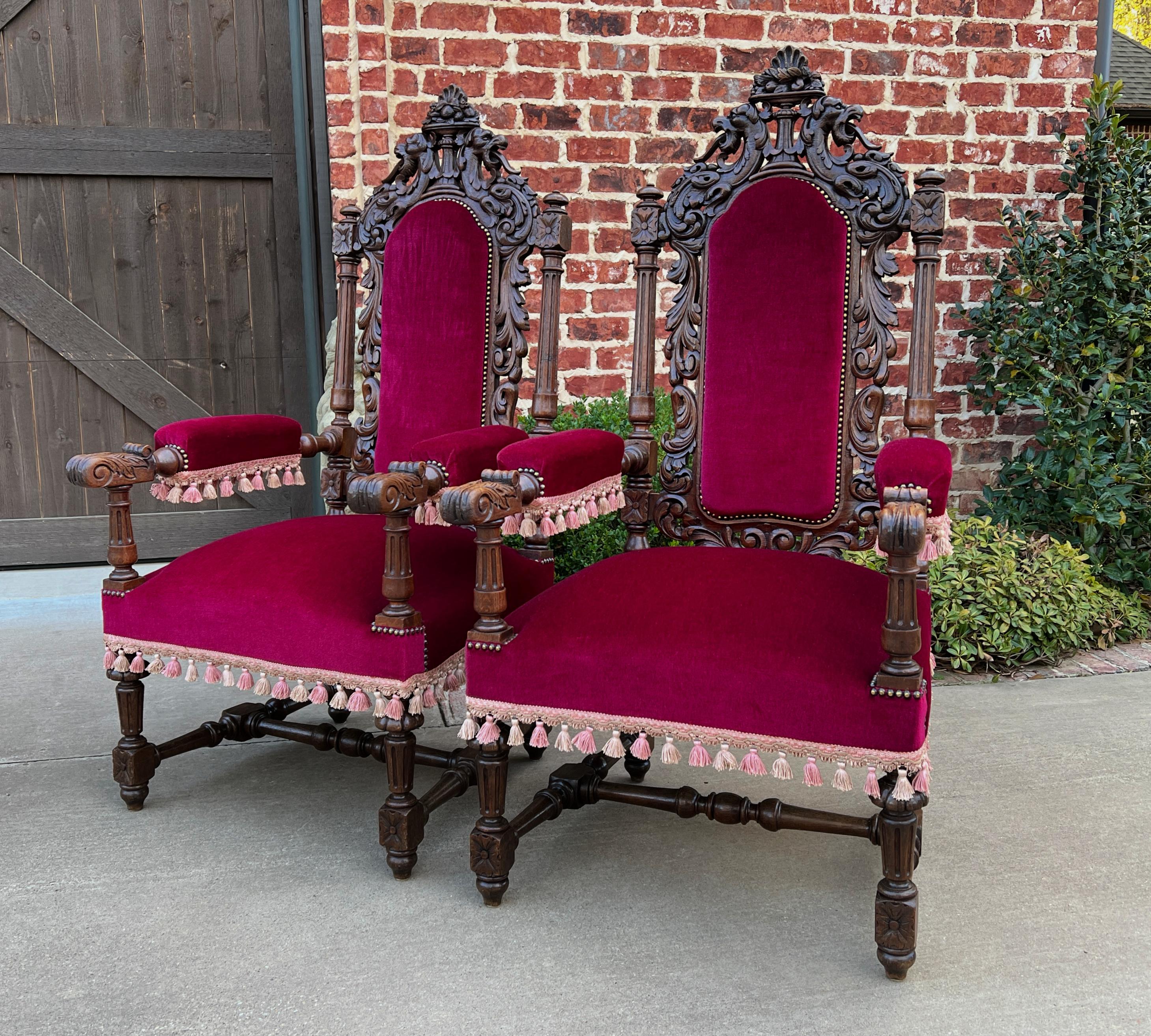 Stunning antique French pair renaissance revival oak upholstered arm chairs throne chairs fireside chairs~~large~~circa 1880s

Classic French charm and style~~stately pair with highly carved backs, arms, and legs

Red velvet or velveteen fabric