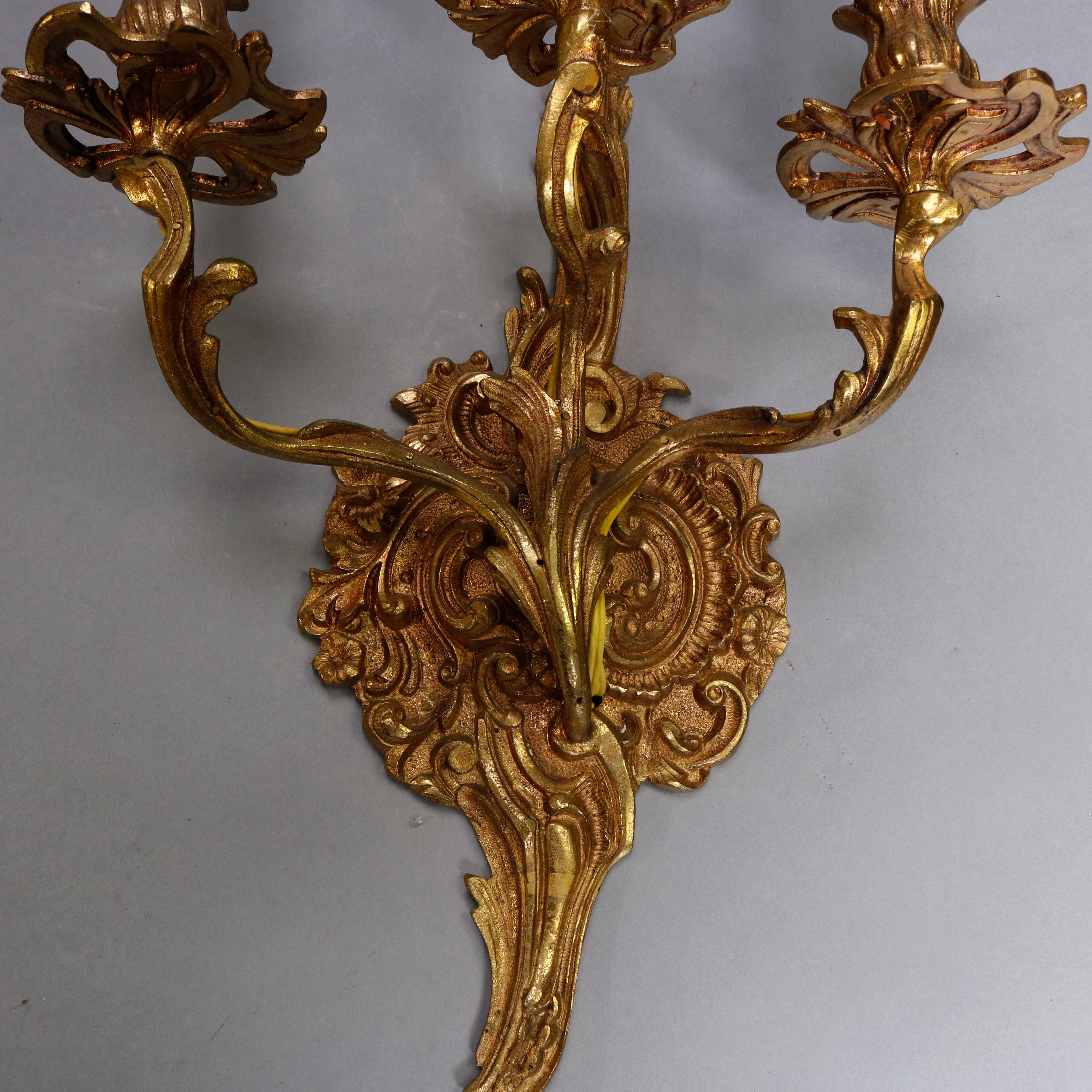 An antique pair of French wall sconces offer gilt cast bronze foliate form each with three candle or light sockets, configured for electric, circa 1880

***DELIVERY NOTICE – Due to COVID-19 we are employing NO-CONTACT PRACTICES in the transfer of