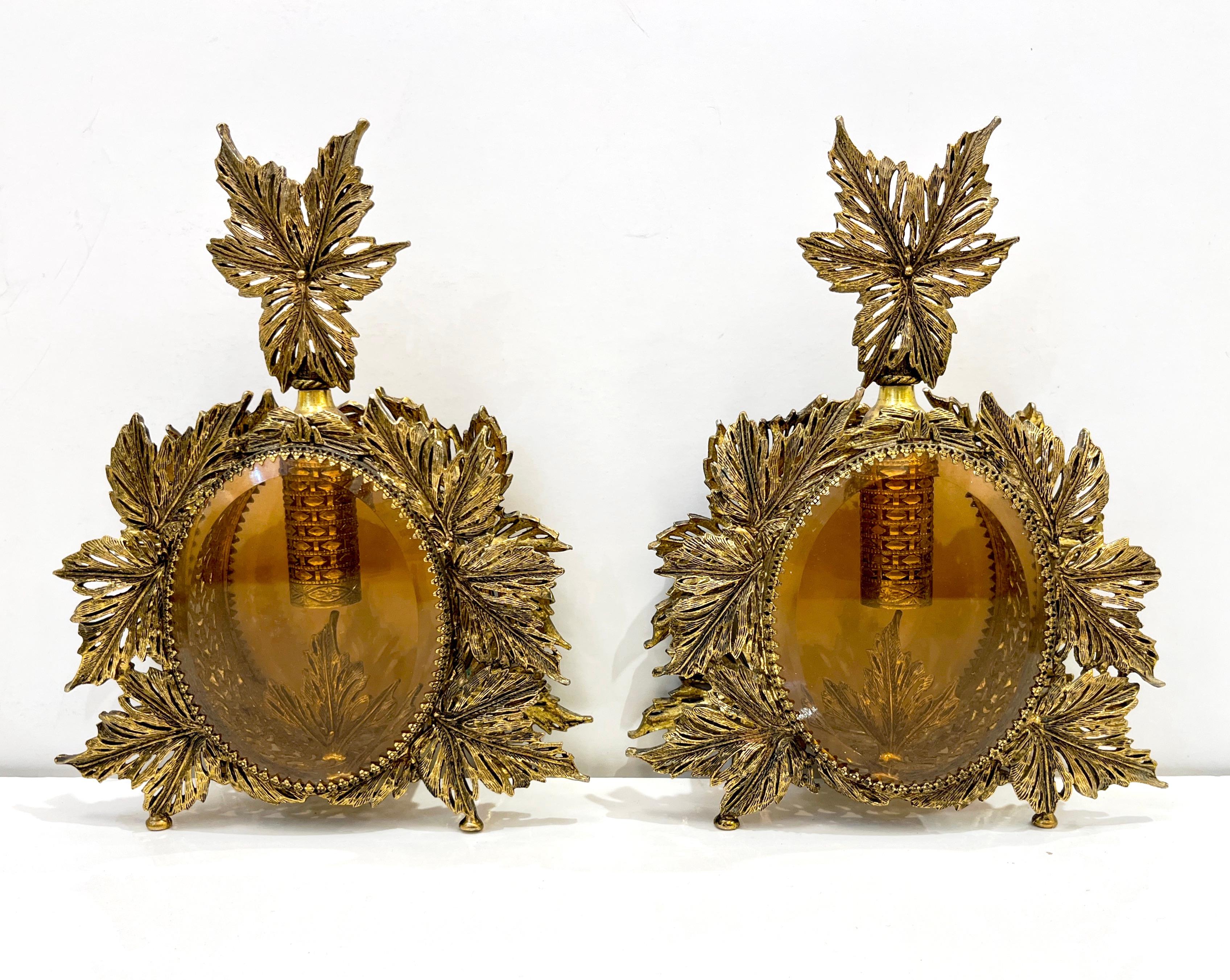 A delightful French luxury pair of antique oversized Ormolu perfume bottles in excellent condition, of the Hollywood Regency period. Extensive Art Nouveau decoration for the pierced and filigree brass work, with perforated leaves all around and on
