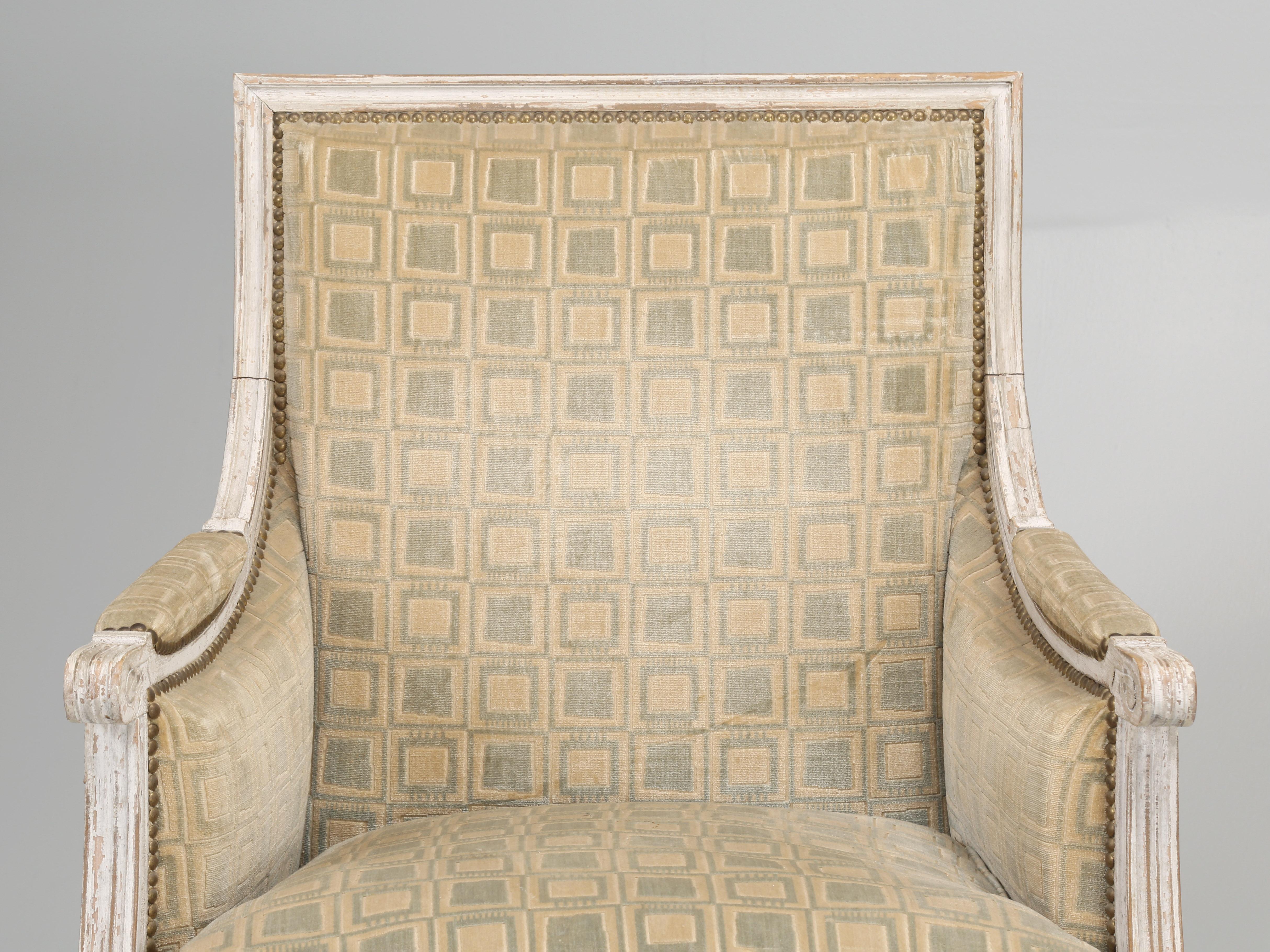 Antique matched pair of French Louis XVI Style Bergère chairs and it’s not very often that we can find an unrestored, all original paint Louis XVI style Bergère chair. By definition, a Bergère chair is an upholstered armchair that originated in the