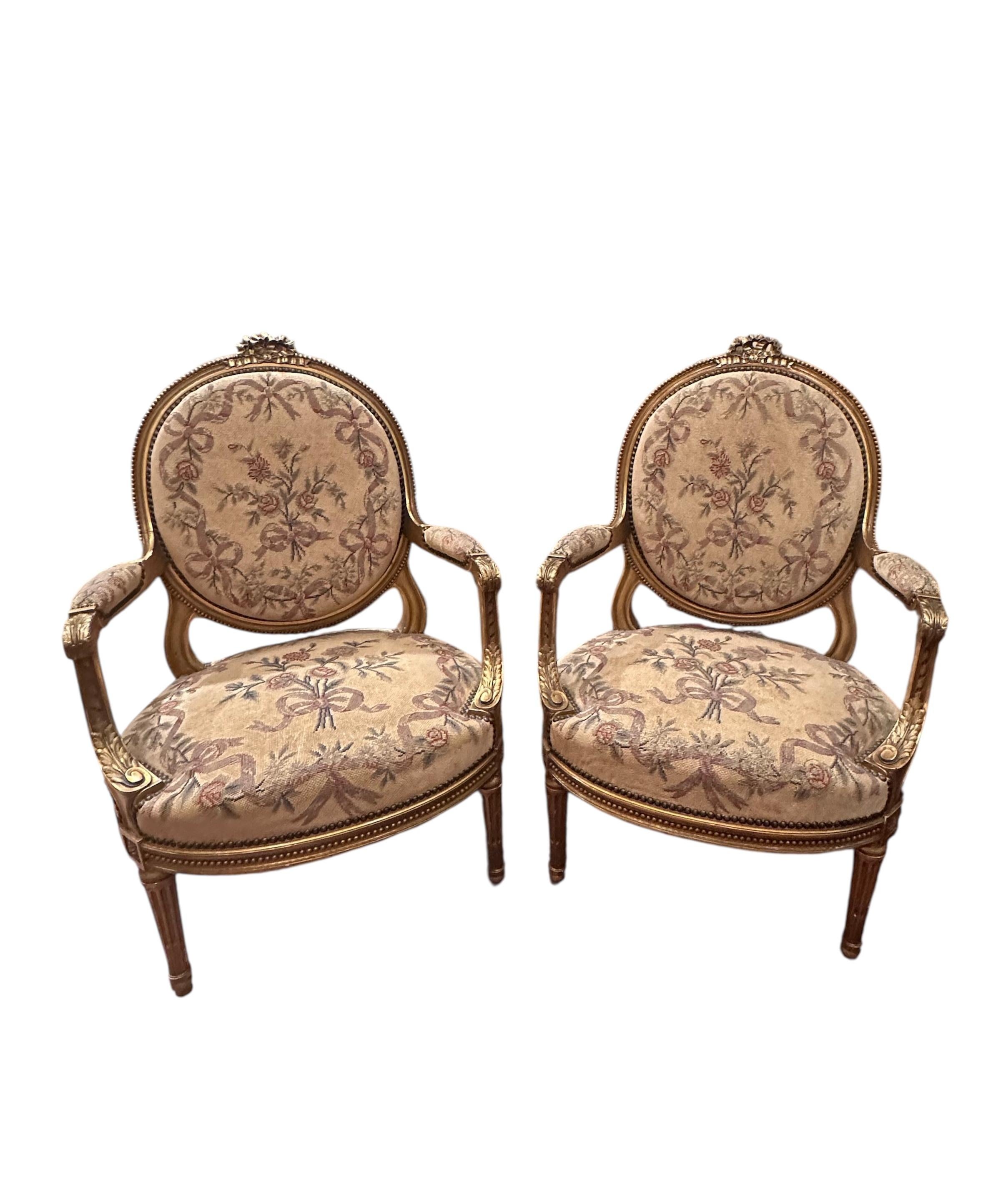 Antique French Pair of Louis XVI Style Carved Giltwood Fauteuils

Two beautiful 19th century carved, gilded and upholstered open armchair fauteuils in French baroque style. They feature elaborate hand carved frames decorated with bead string design,
