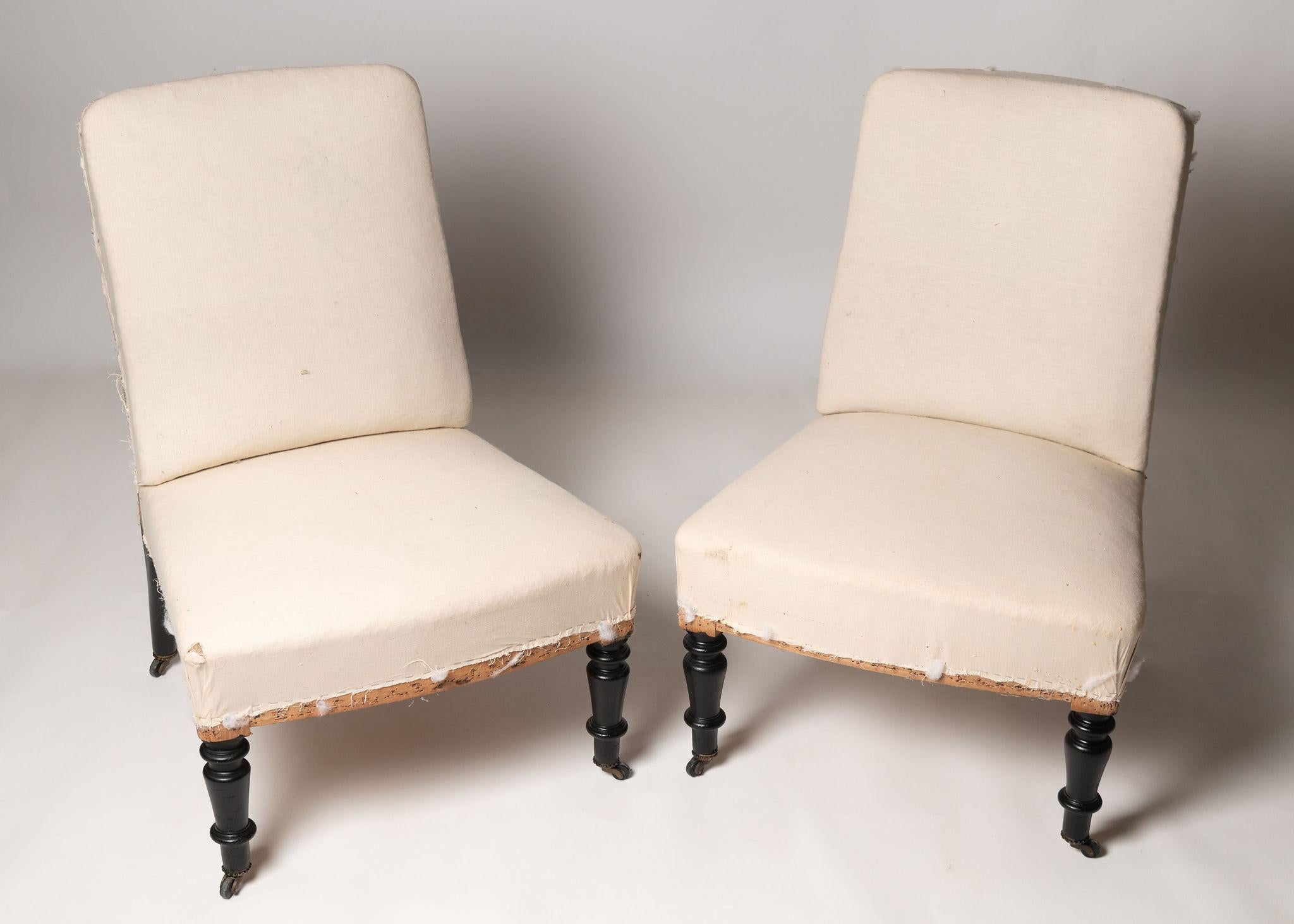 Antique French pair of Napoleon III slipper chairs, seat depth 16.5 inches. Ideal fireside, bedroom or occasional chairs. 19th Century. Ready for your upholstery. 