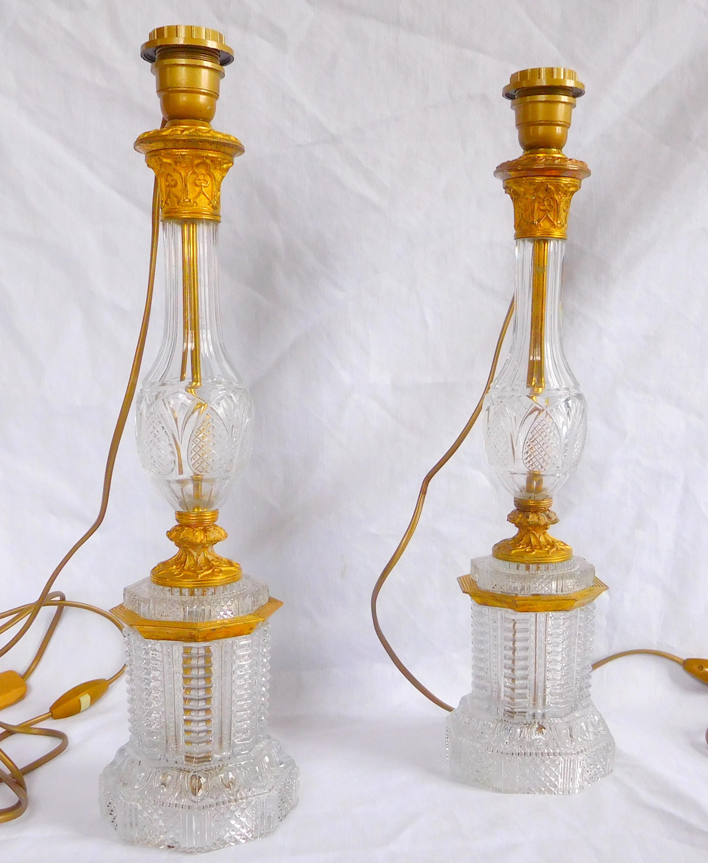Pair of tall crystal and ormolu (gilt bronze) lamps. Beautiful, finely cut diamond-shaped pattern. Attributed to Le Creusot Manufacture, Royal crystal manufacture in early 19th century.

Empire / Restauration period, early 19th century production