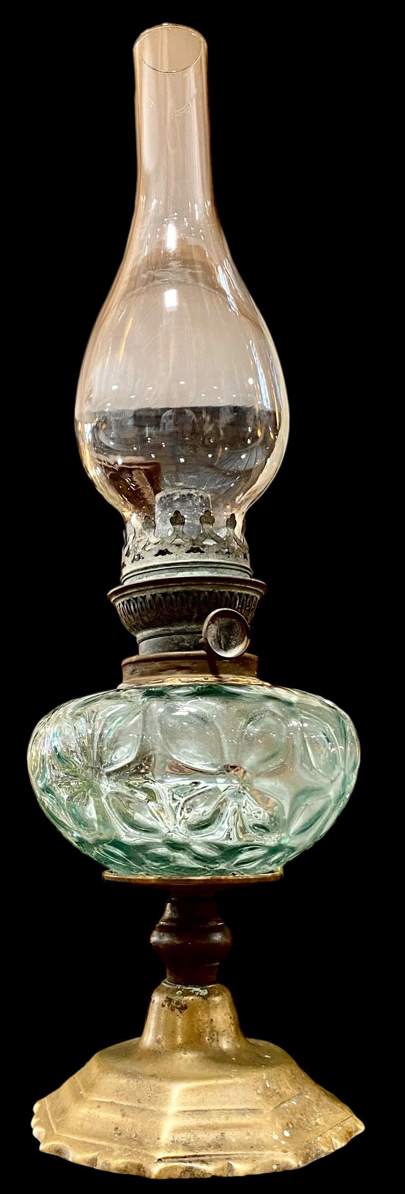 An antique French pale blue optic glass oil lamp from the Belle Epoch era, 1890s. 
Absolutely lovely shade of pale blue optic glass font with brass base, The glass in the form of charming stylized flowers, The base in a brass plated simple circular