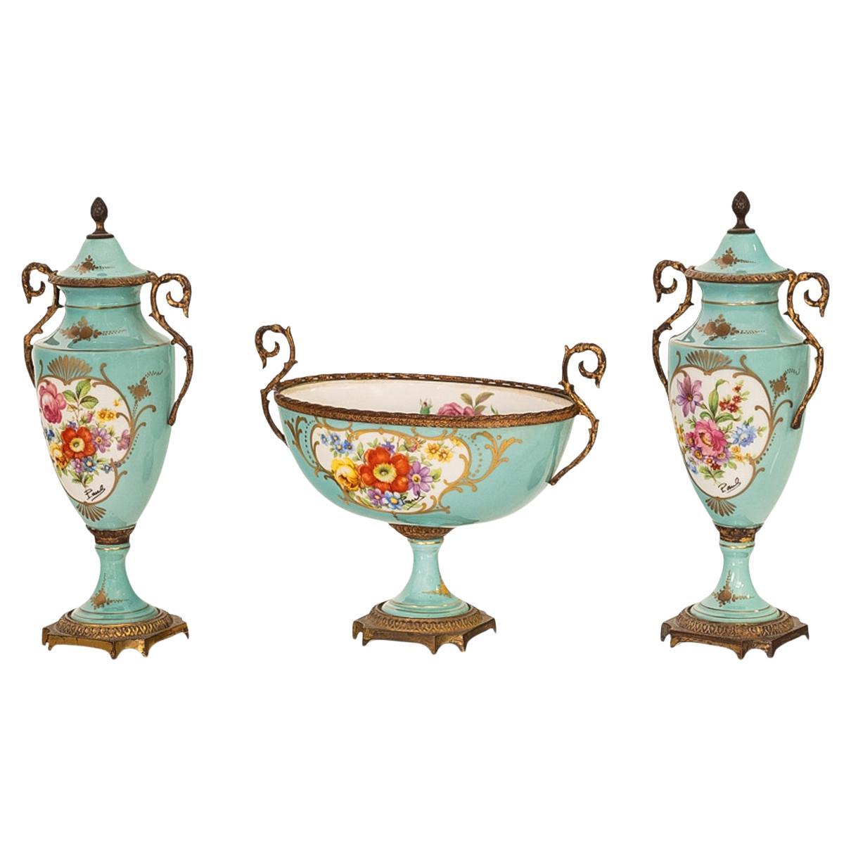 Antique, 3 piece French 'Sevres' style Porcelain de Paris & gilt-bronze garniture, signed, circa 1915.
The garniture comprising a pair of lidded, twin handled urns & a matching twin handled coupe or bowl. The lidded urns with bronze 'pineapple'