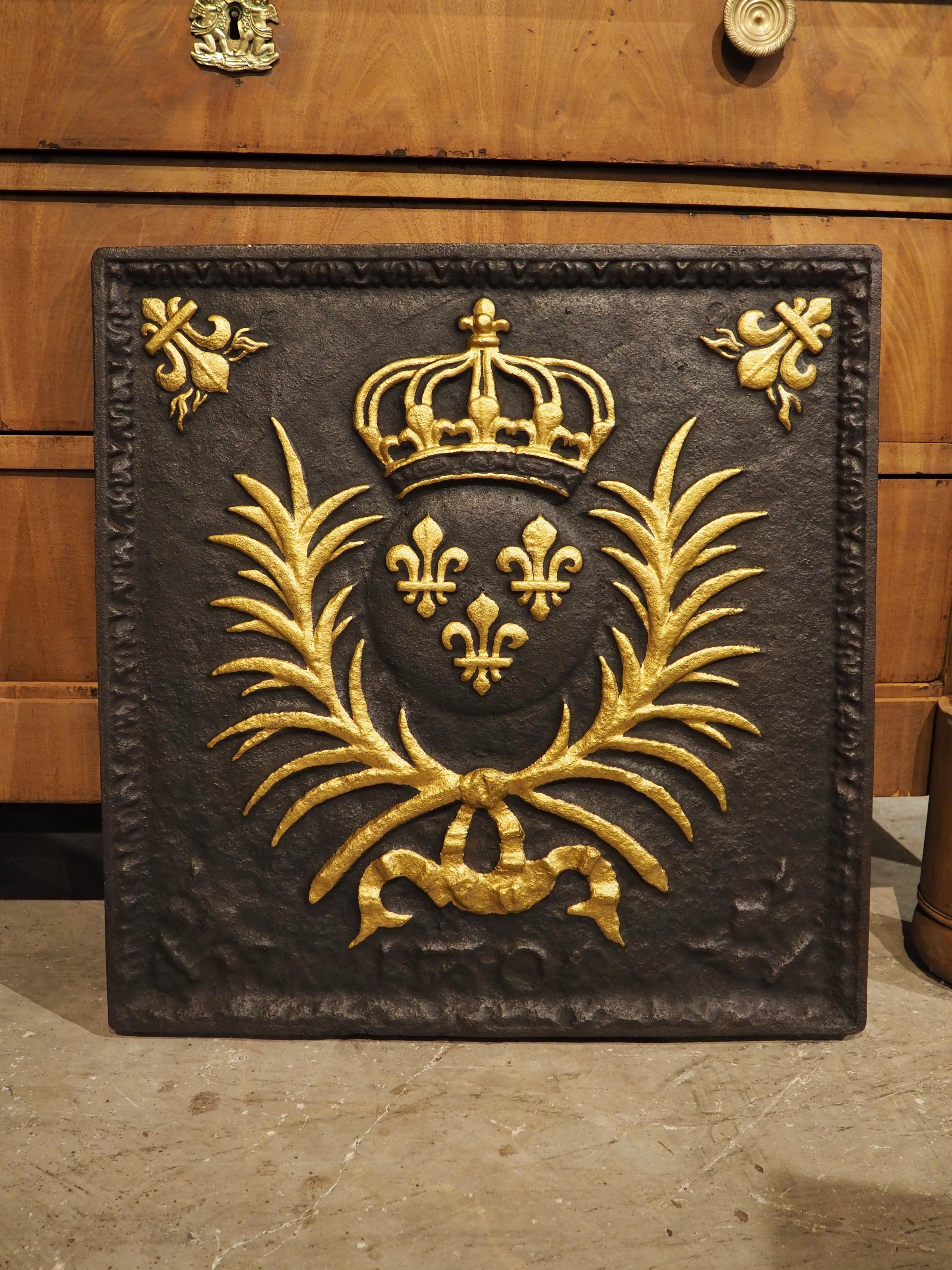 This almost square cast iron fireback from the 1800’s depicts a version of the Arms of France.

Before 1376, fleur de lys were presented on the Arms of France as seme, or an indefinite number. In this year, Charles V of France reduced the number of