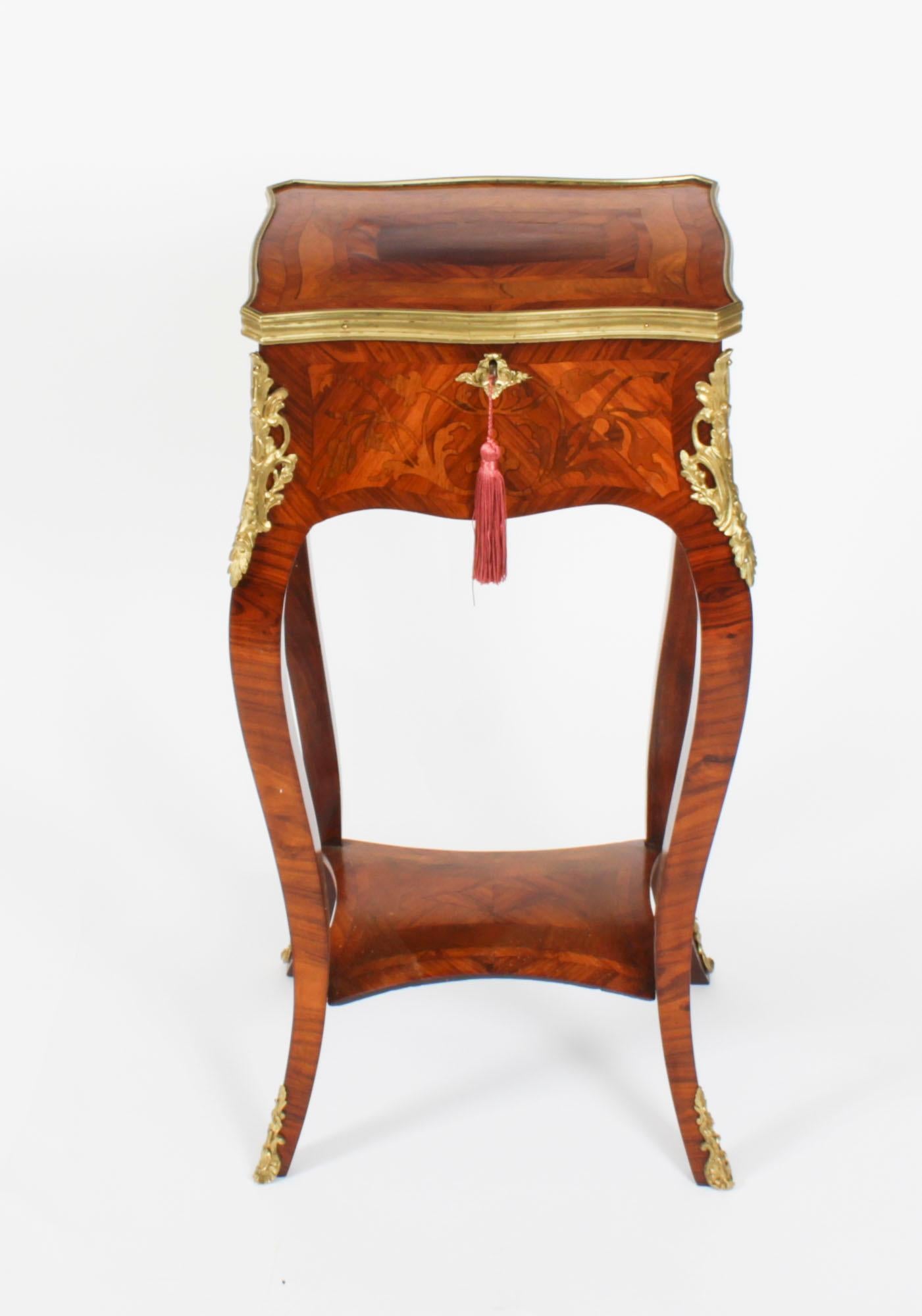 This is a beautiful antique French Louis Revival parquetry and marquetry ormolu mounted serpentine side table, circa 1850 in date.

The ormolu banded lid has a Horne's patent hinge with beautiful banded parquetry decoration opening to a casket for