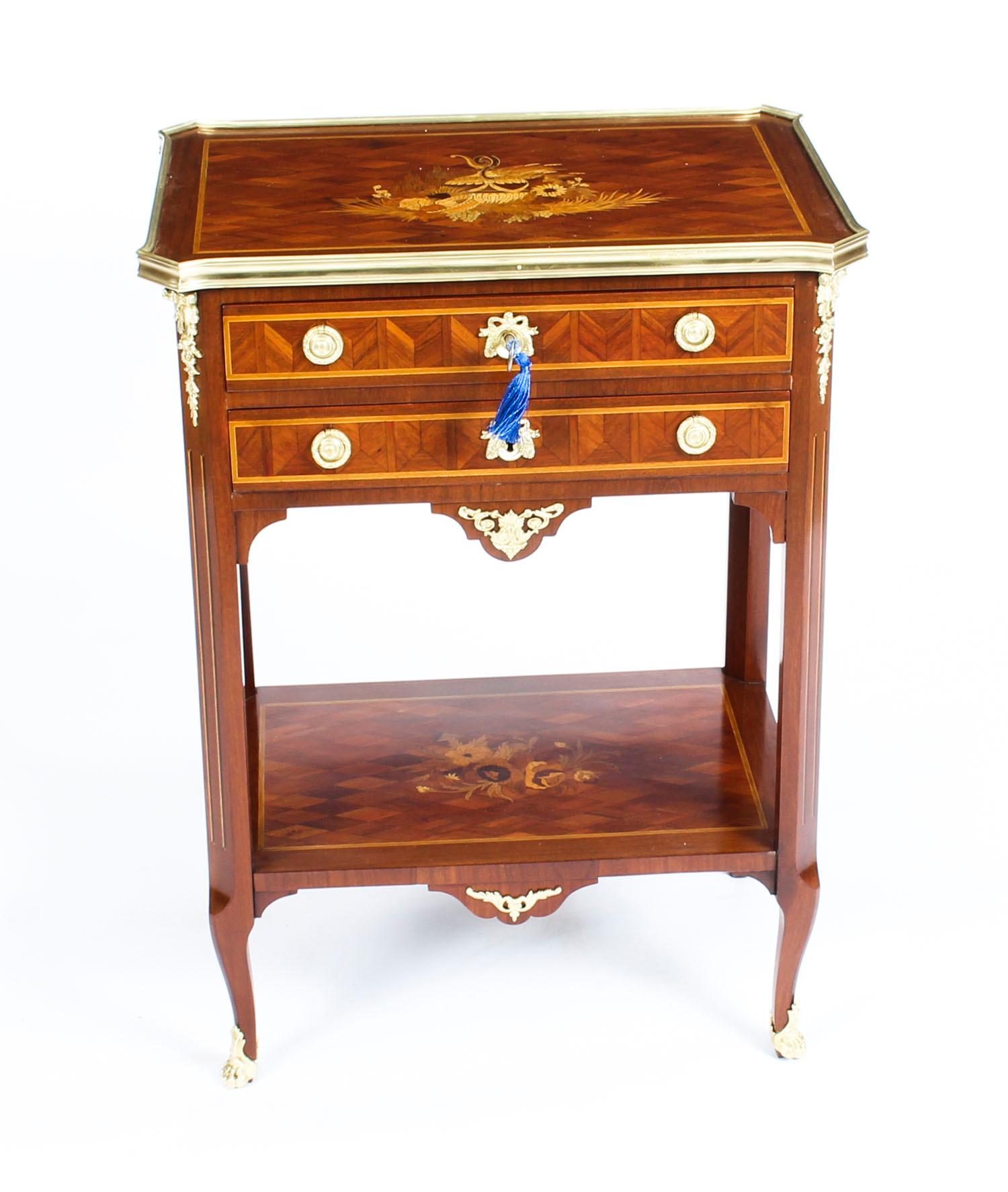 This is a wonderful antique French parquetry and marquetry ormolu-mounted occasional work table or table en chiffonière in the Transitional style, circa 1870 in date.

The ormolu banded top with beautiful floral marquetry and outset canted corners,