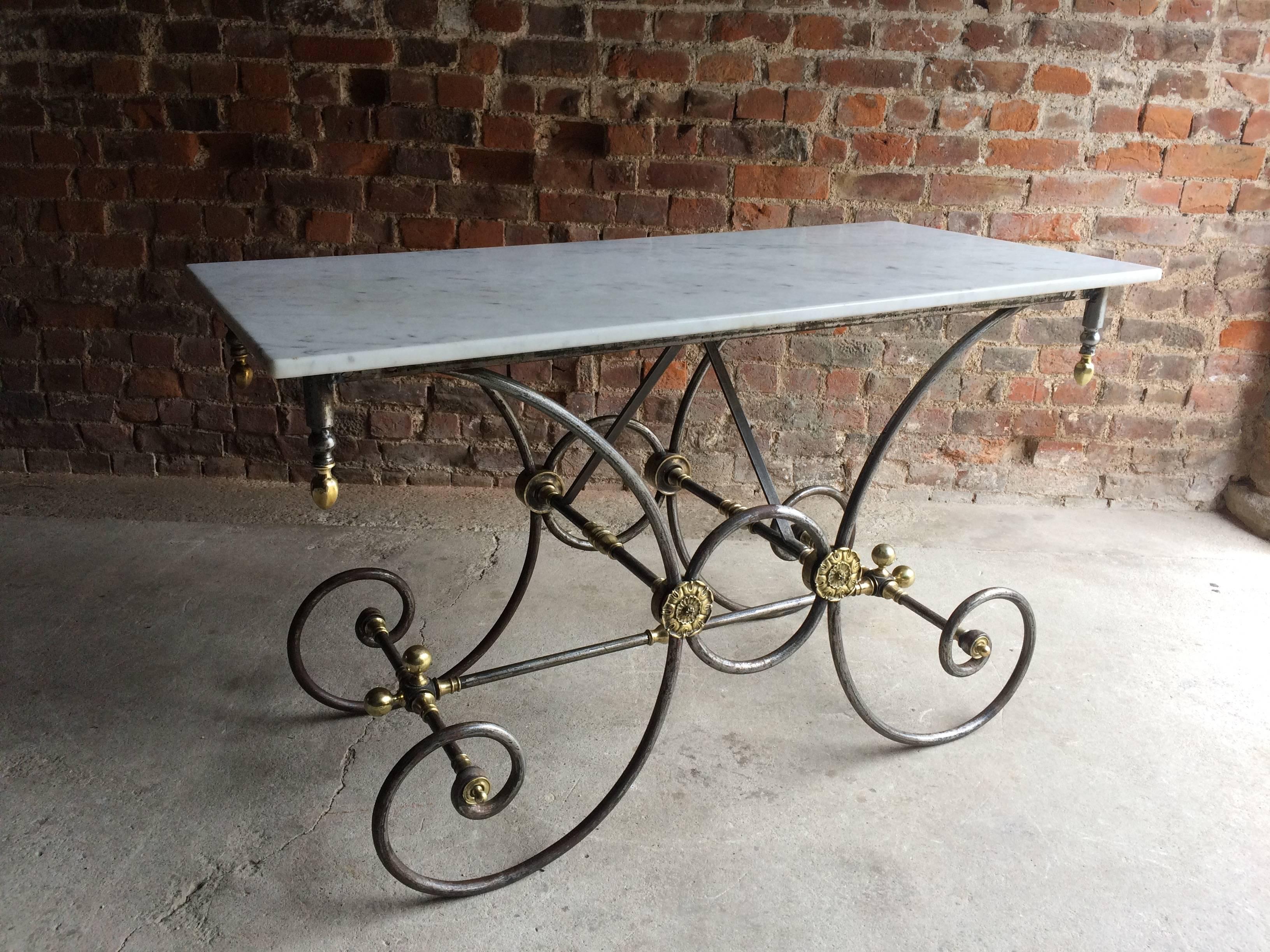 Magnificent and authentic French pastry table dating to circa 1890, with fabulous scrolling wrought iron base featuring a clean white marble-top with decorative brass finials, a truly gorgeous piece of furniture that is very sought after and