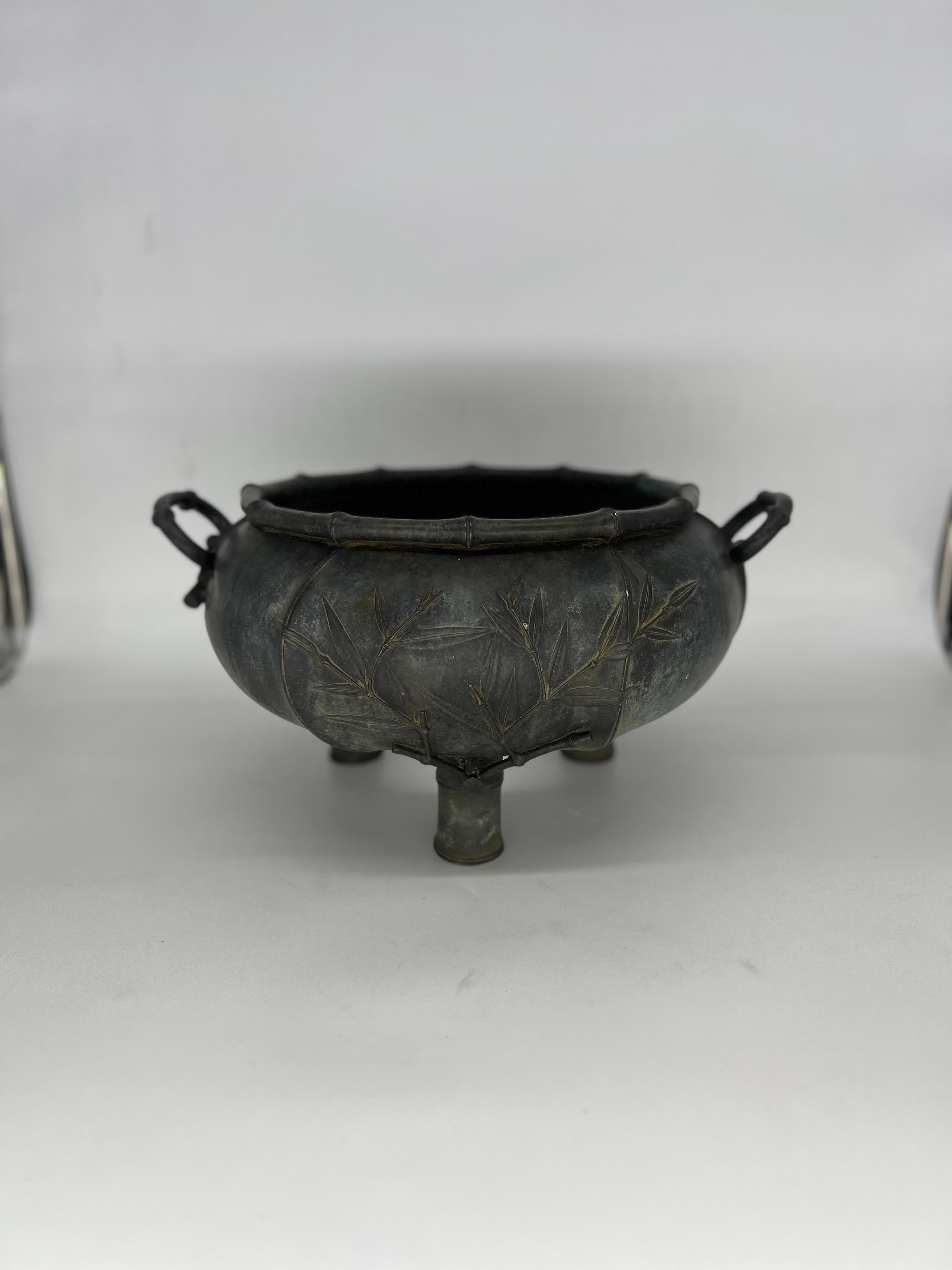 Fine quality bronze planter likely made from a skilled French bronze smith. The tripod form is adorned with bamboo motifs to body, rim and handles. Two drain holes to feet. No apparent markers mark but of fine quality. Provenance: Estate of Governor