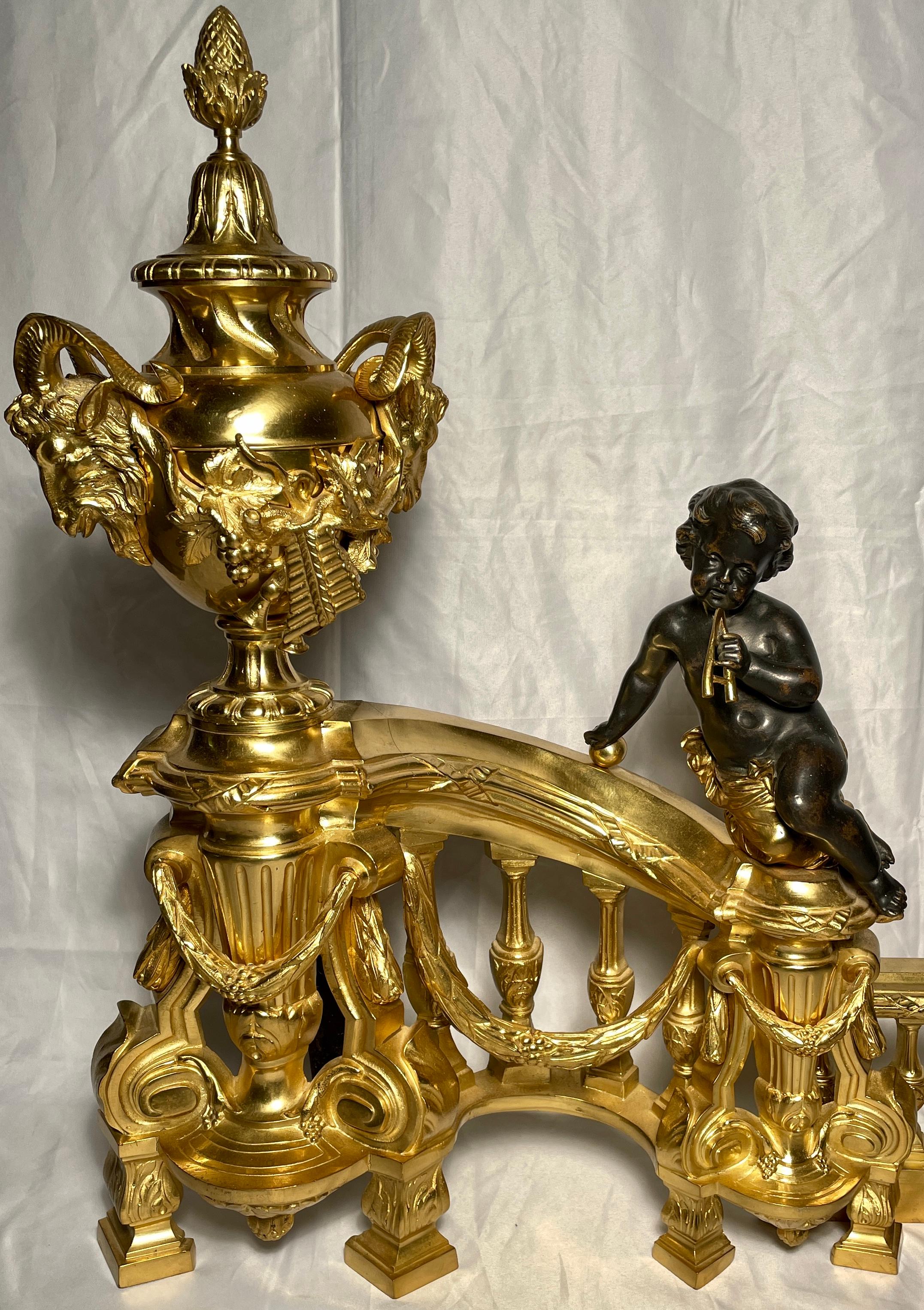Magnificent antique French gold bronze and patinated bronze chenets / andirons with cherubs, circa 1865-1875.
