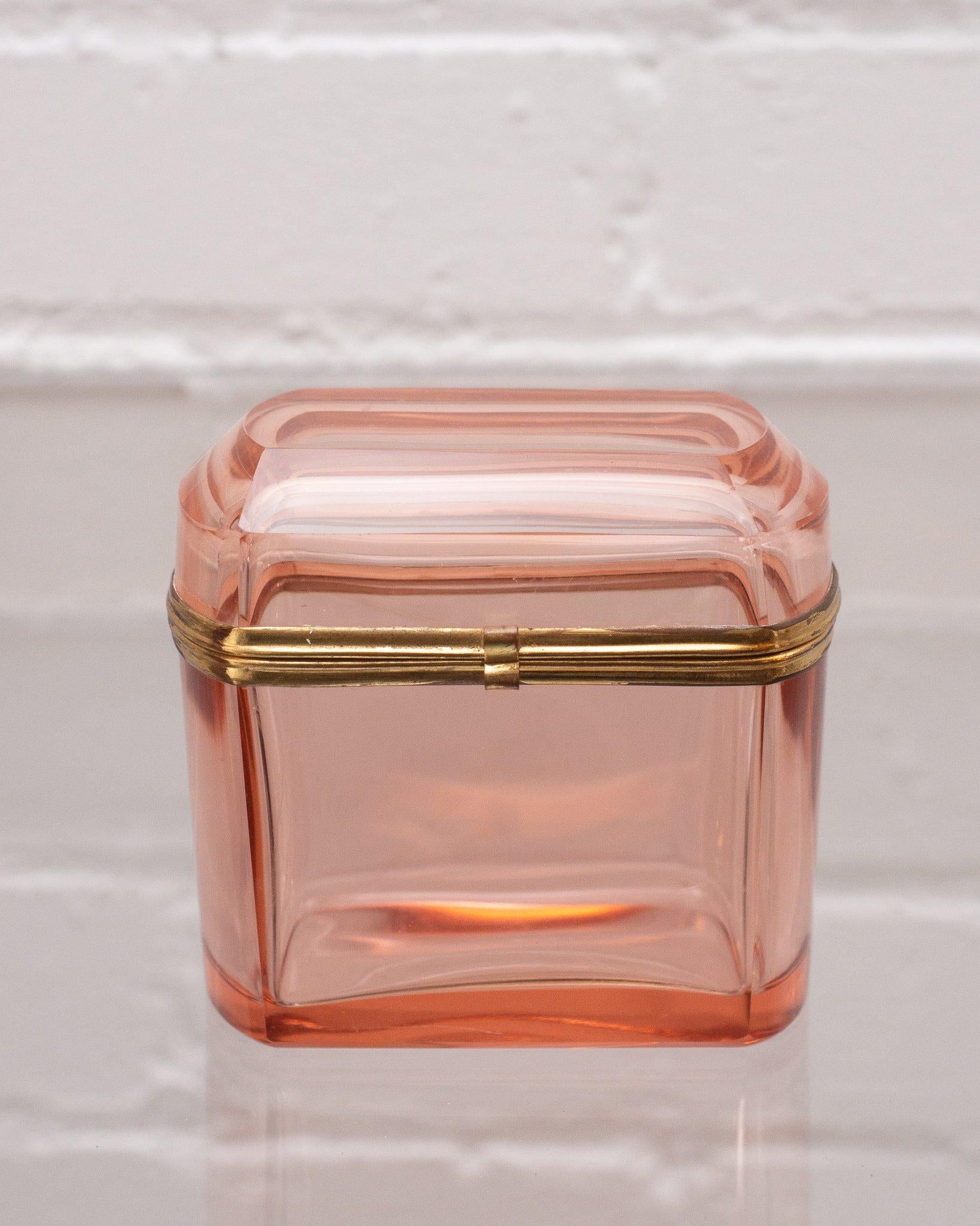 This antique French peach crystal and bronze box makes a statement in any space. An early 1900s production, this piece transitions from modern to Classic interiors seamlessly with its sophisticated shape and light catching quality.