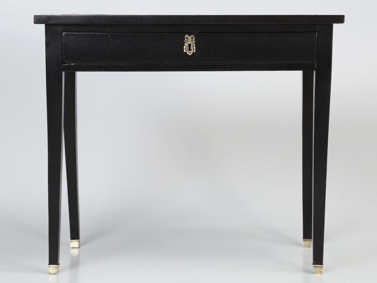 Antique French Directoire style ladies writing desk or side table. Our old plank restoration department, hand-stripped the mahogany writing desk to the bare wood, restored the desk structurally and applied an ebony finish to the exterior of the