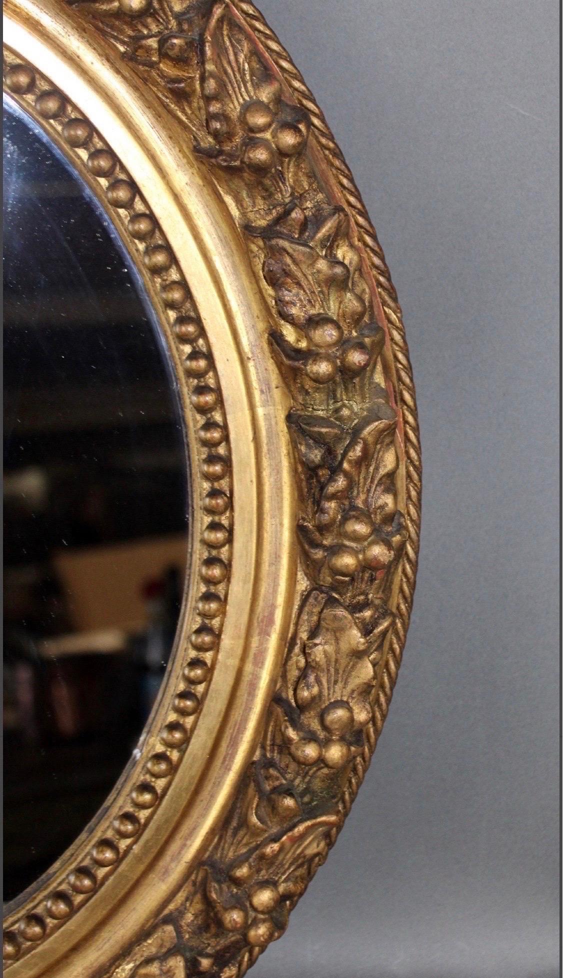 Louis XVI Antique French Petite Giltwood Oval Mirror with Relief Carved Grape Vine Foliage