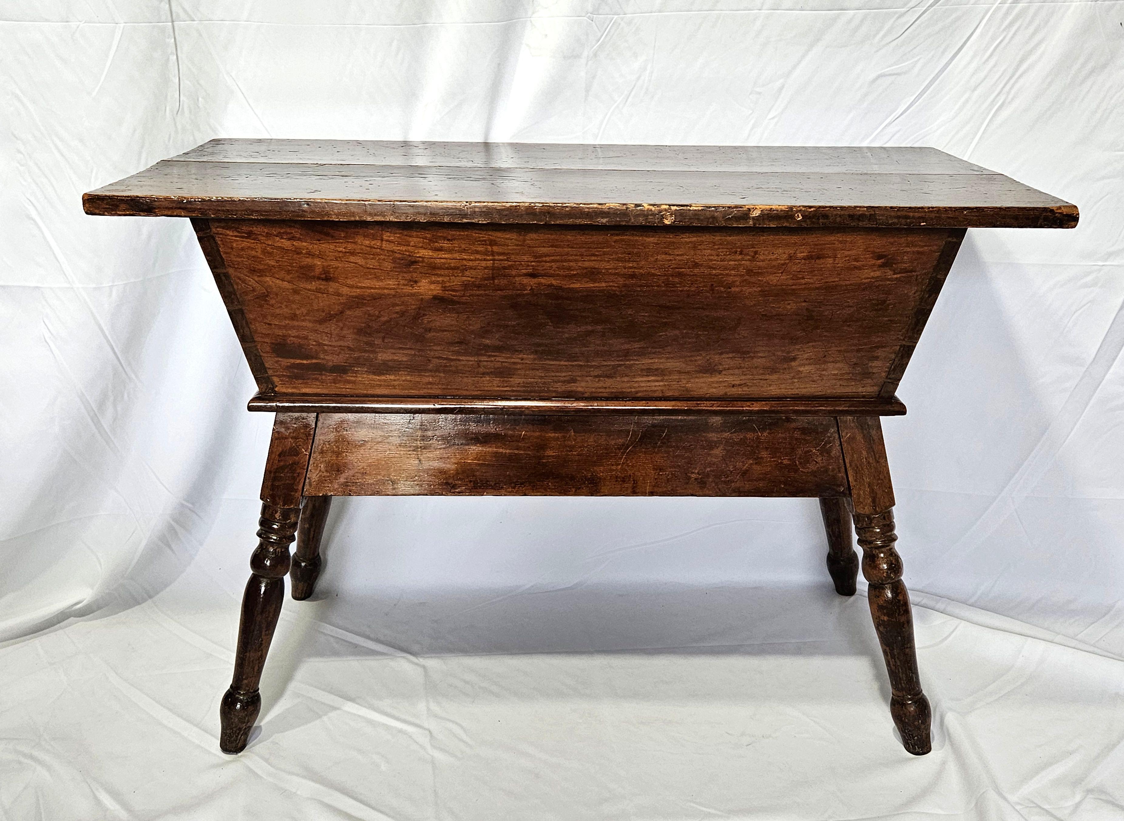 A rare find is a handcrafted French Oak Kneading Dough Table from the early 19th century. This is a French bread dough trough which is a typical sight in the kitchens of large homes. The dough would be kneaded on the countertop and placed inside the