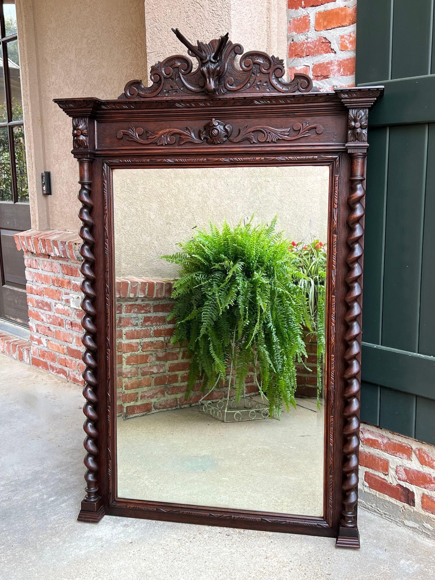Antique French Pier mantel wall mirror black forest barley twist carved oak stag.

Direct from France, a gorgeous hand carved 19th century French pier/mantel mirror, over 6 ft. tall with outstanding detail!! 
The details reveal it was probably