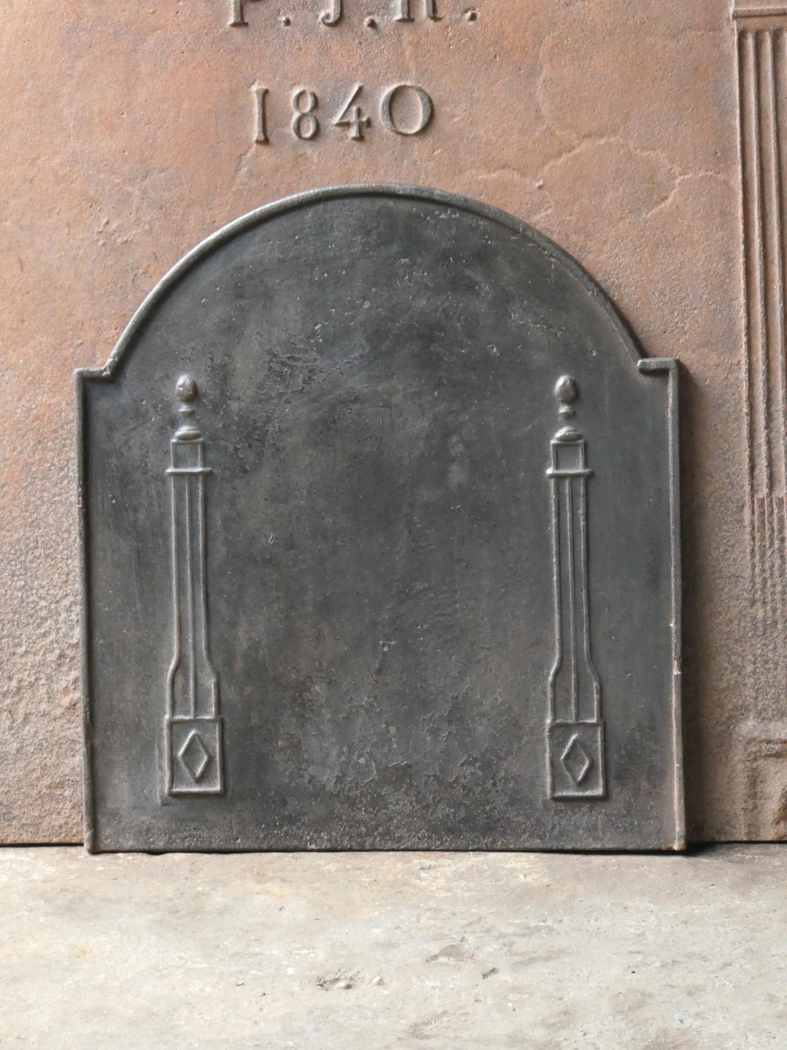 18th - 19th century French neoclassical fireback with two pillars of freedom. The pillars symbolize the value liberty, one of the three values of the French revolution. 

The fireback is made of cast iron and has a natural brown patina. Upon