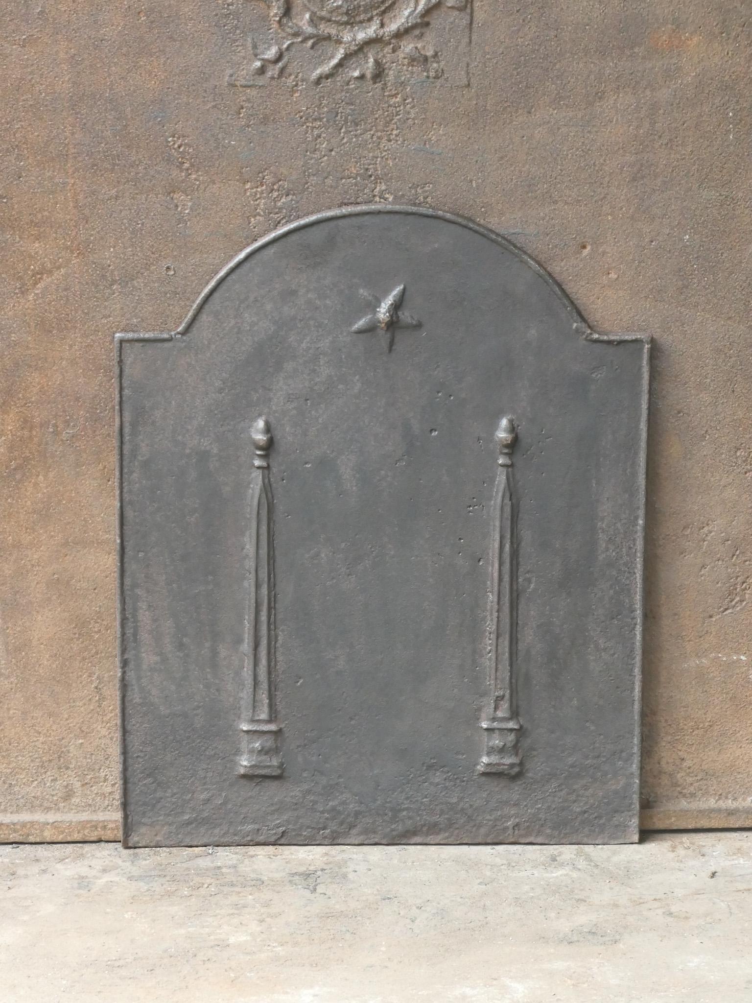 18th - 19th century French neoclassical fireback with two pillars of freedom. The pillars symbolize the value liberty, one of the three values of the French revolution. 

The fireback is made of cast iron and has a natural brown patina. Upon request
