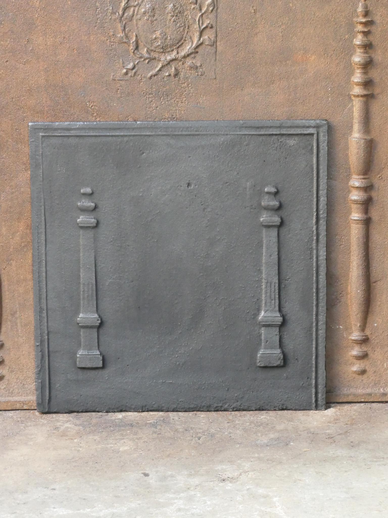 18th - 19th century French neoclassical period fireback with two pillars of freedom. The pillars symbolize the value liberty, one of the three values of the French revolution. 

The fireback is made of cast iron and has a black / pewter patina. It