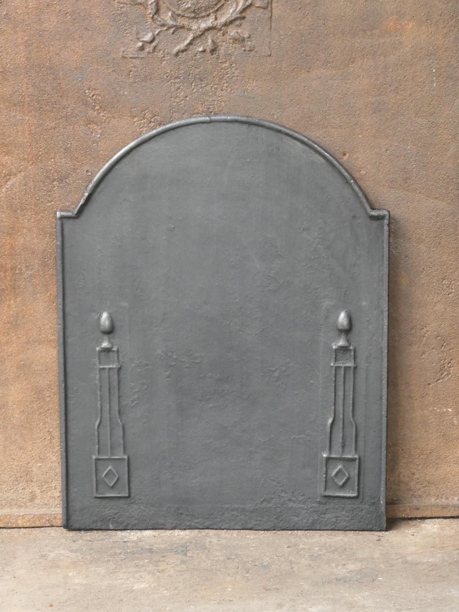 Late 18th or early 19th century French neoclassical period fireback with two pillars of freedom. The pillars symbolize the value liberty, one of the three values of the French revolution. 

The fireback is made of cast iron and has a black / pewter