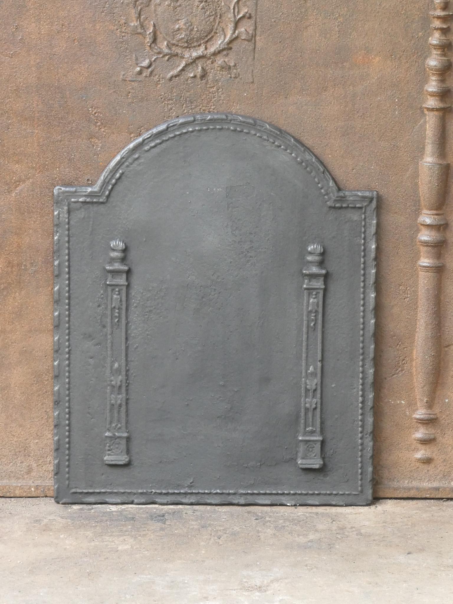 Late 18th or early 19th century French neoclassical period fireback with two pillars of freedom. The pillars symbolize the value liberty, one of the three values of the French revolution. 

The fireback is made of cast iron and has a black / pewter
