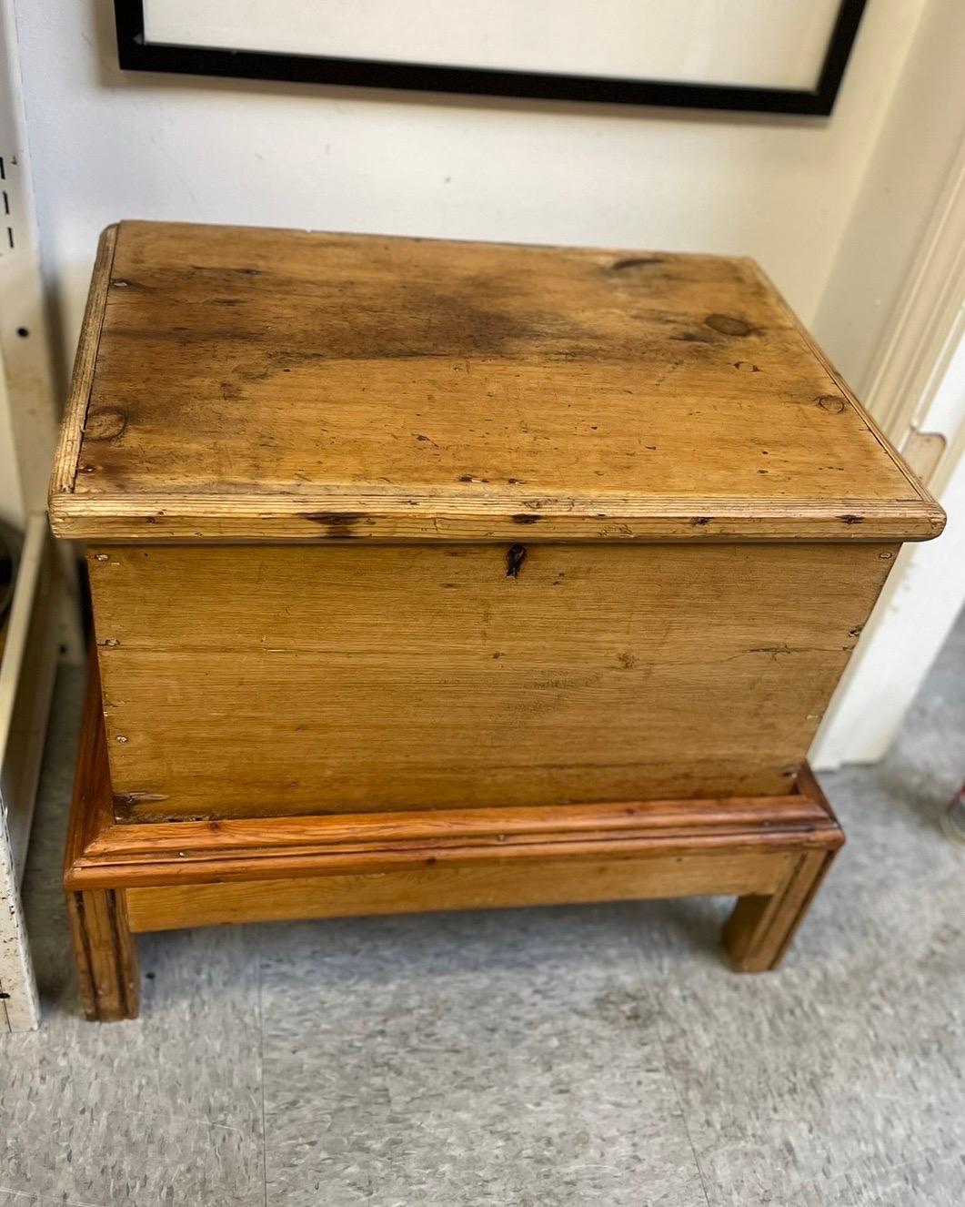 A fantastic late 19th century French pine petite chest on a pine stand.   This could have originally been used for silverware or a small blanket chest.  All original hardware and hand planed.   As of recent it was used as a side table in between 2