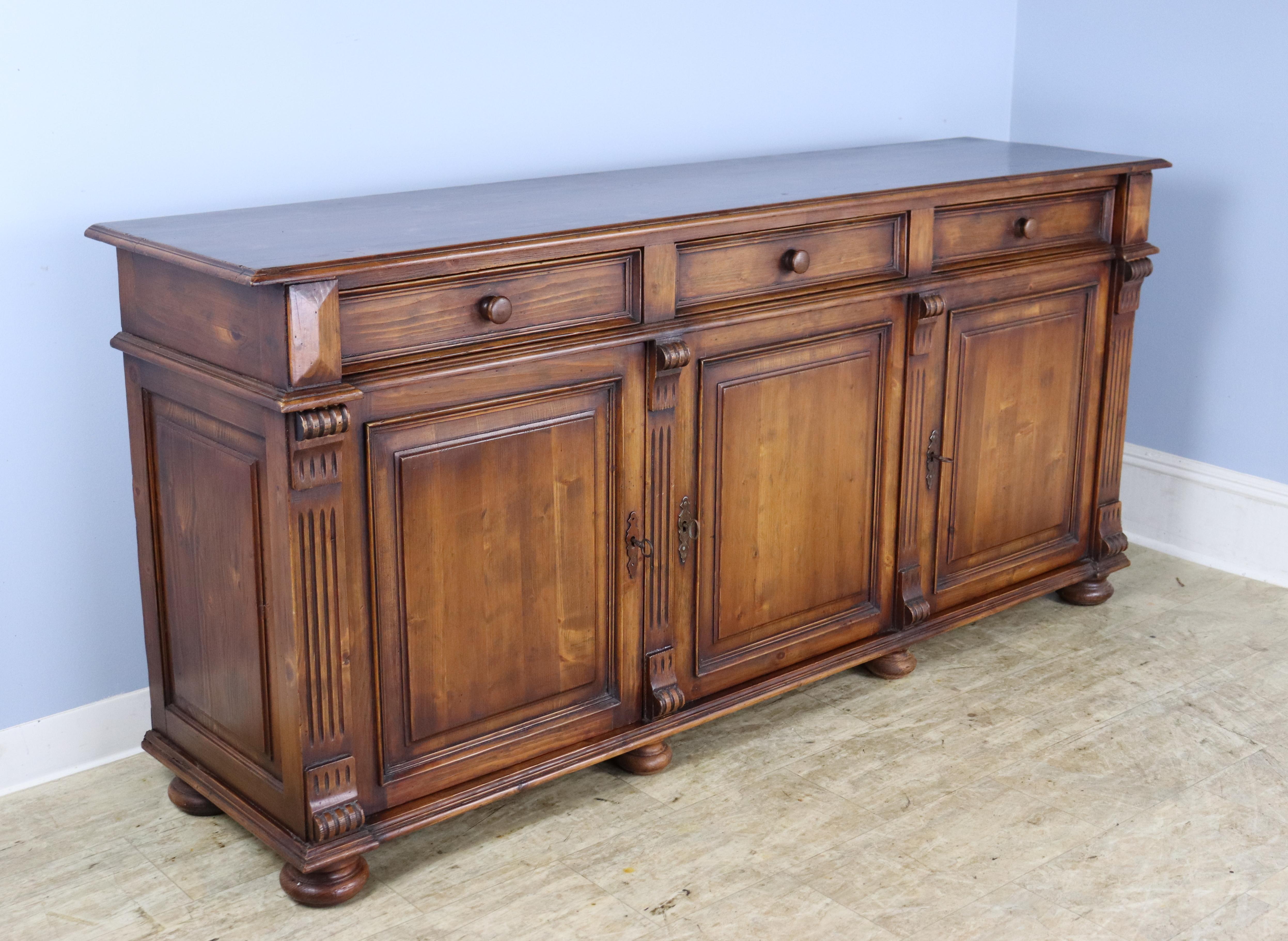 A handsome pine enfilade or buffet from France.  Great details such as reeded carvings along the doors, elegant moldings and good bun feet.  Each door has its own original key, and the interior shelving is non-adjustable.