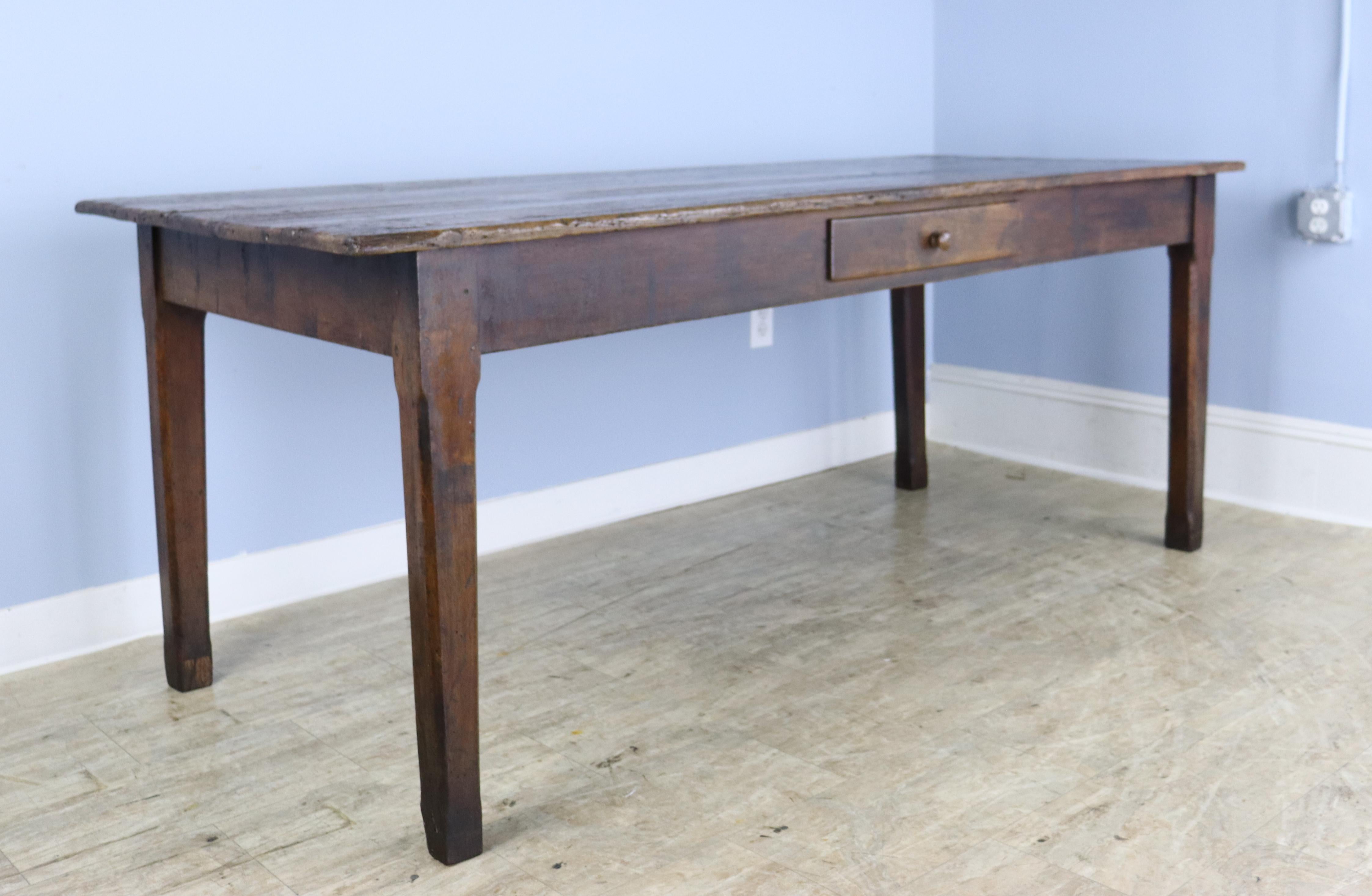 A handsome country pine farm table from France with very good color and patina.  Classic tapered legs, nicely pegged at the apron.  Single useful drawer that opens and closes well.  The apron height of 24.25 inches is good for knees, and there are