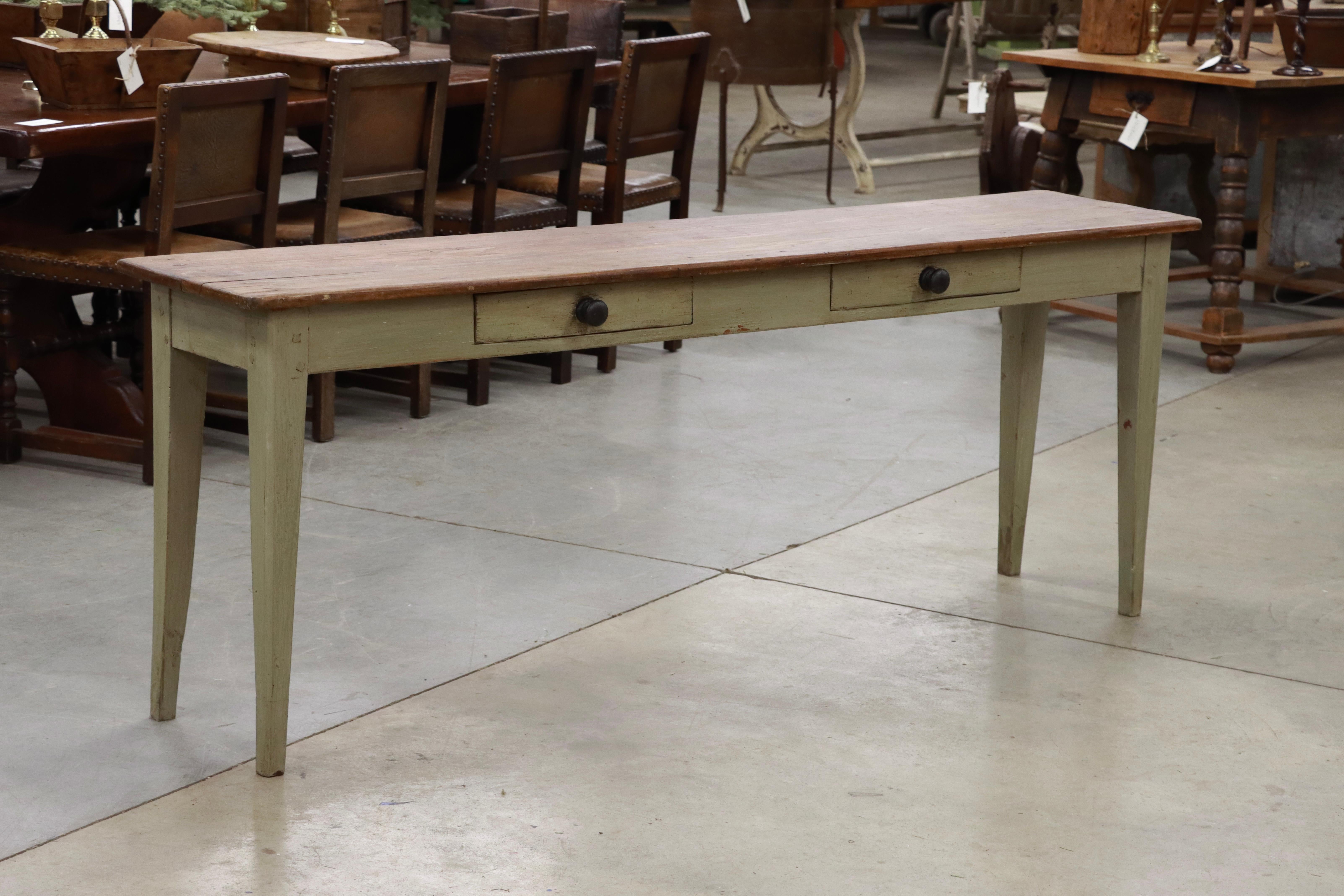 Antique pine 2-drawer Burgundian French serving table on slightly splayed legs. The table base, which has a later paint finish, is a very attractive pale green in contrast with a polished top.