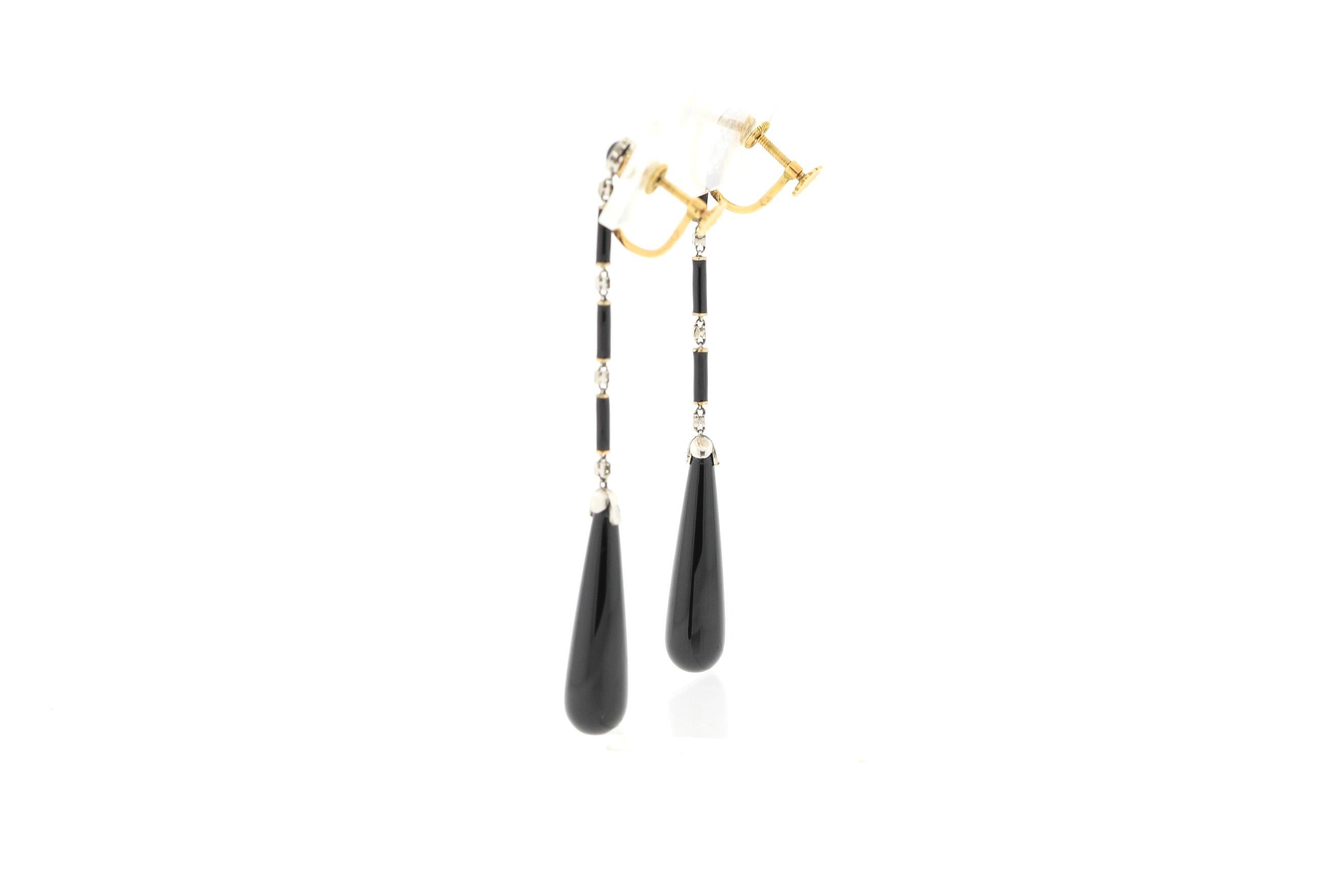 Antique dramatic onyx drop earrings set with small rosecut diamonds in platinum, circa 1910. The earrings are a definite stylistic lead in to the Art Deco era with the popularity of long swinging earrings. They have screw backs, that can be easily