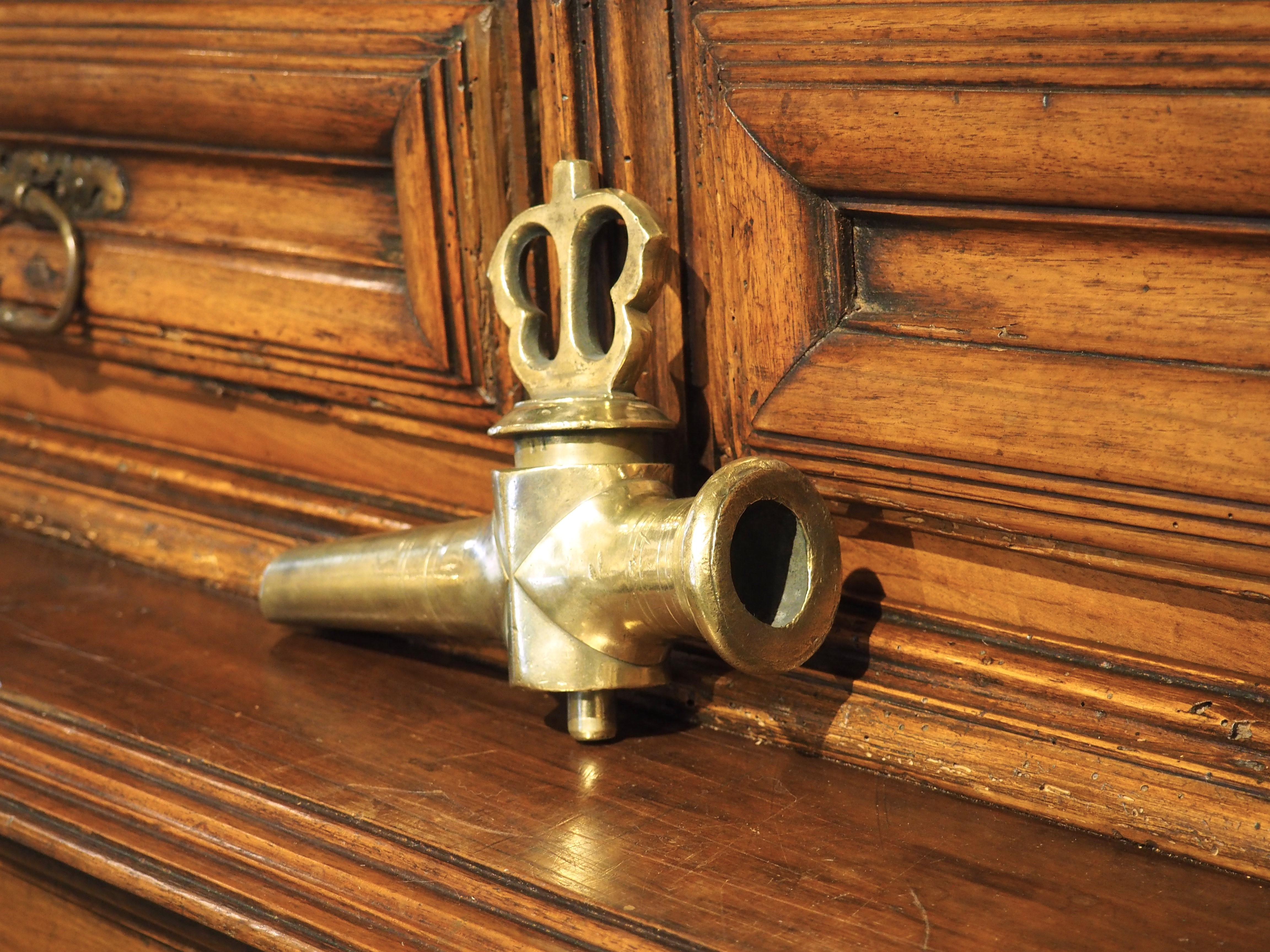 Originally a spout for a French wine barrel, this polished bronze spout has a pierced turn valve resembling a butterfly. The spout, which dates to the 1800s, is also embellished with several thin rings of fluting on the horizontal pipe and geometric