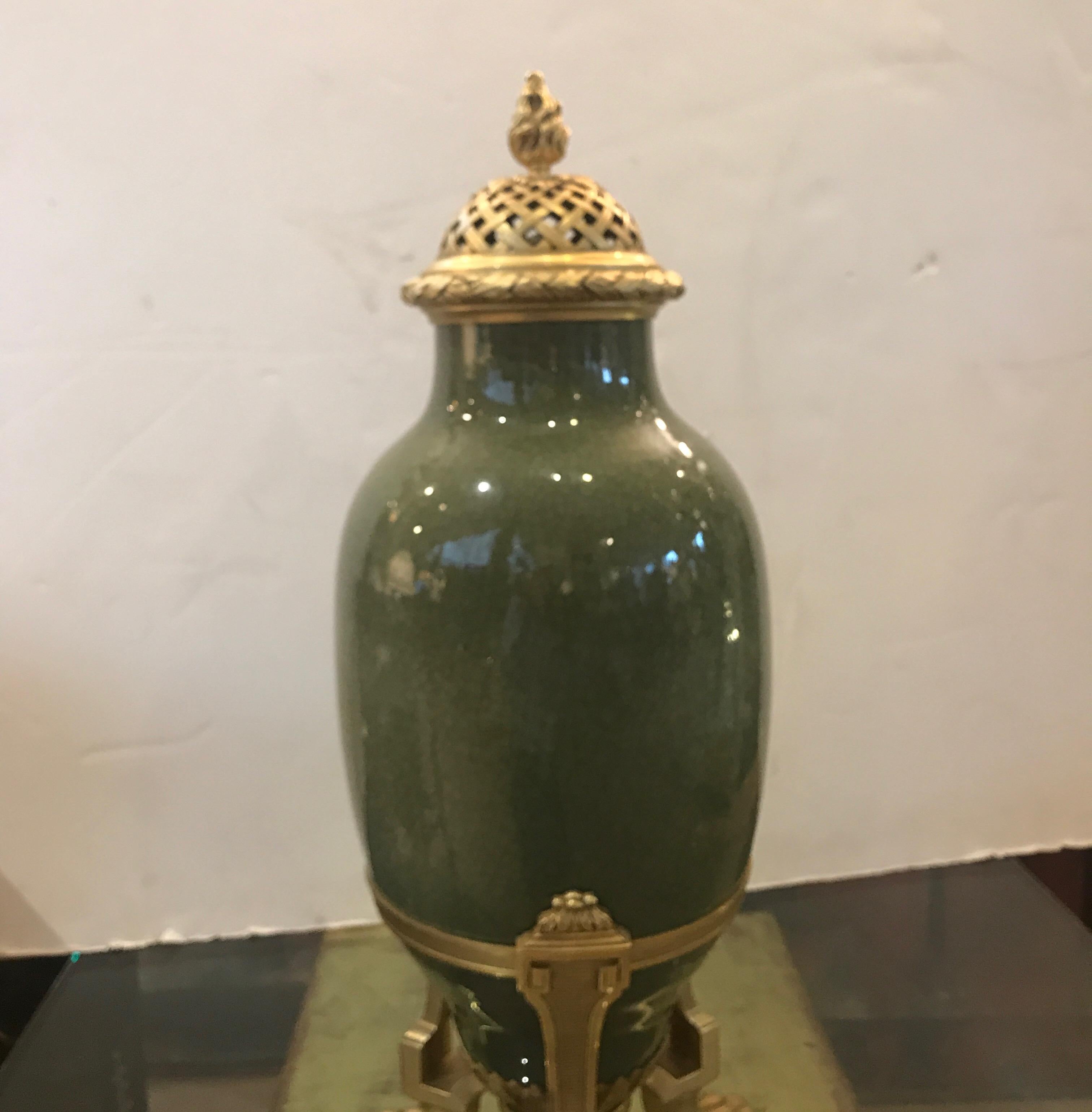 Large antique French porcelain urn with gilt bronze mounts. The urn, in a sage green glazed porcelain with a crackle finish. The well cast bronze mounts with reticulated lid. Marked on the bottom edge, made in France. The diameter of the urn is 9