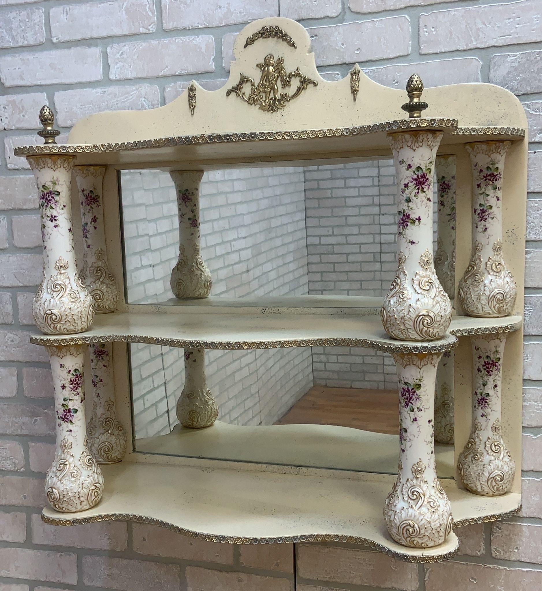 Antique French Hand Painted Porcelain Columned Brass Mounted Mirror Back Dresden Style Wall/Vanity Shelf

Imbued with the grace of Antique French design, this hand-painted porcelain columned wall/vanity shelf stands as a testament to exquisite