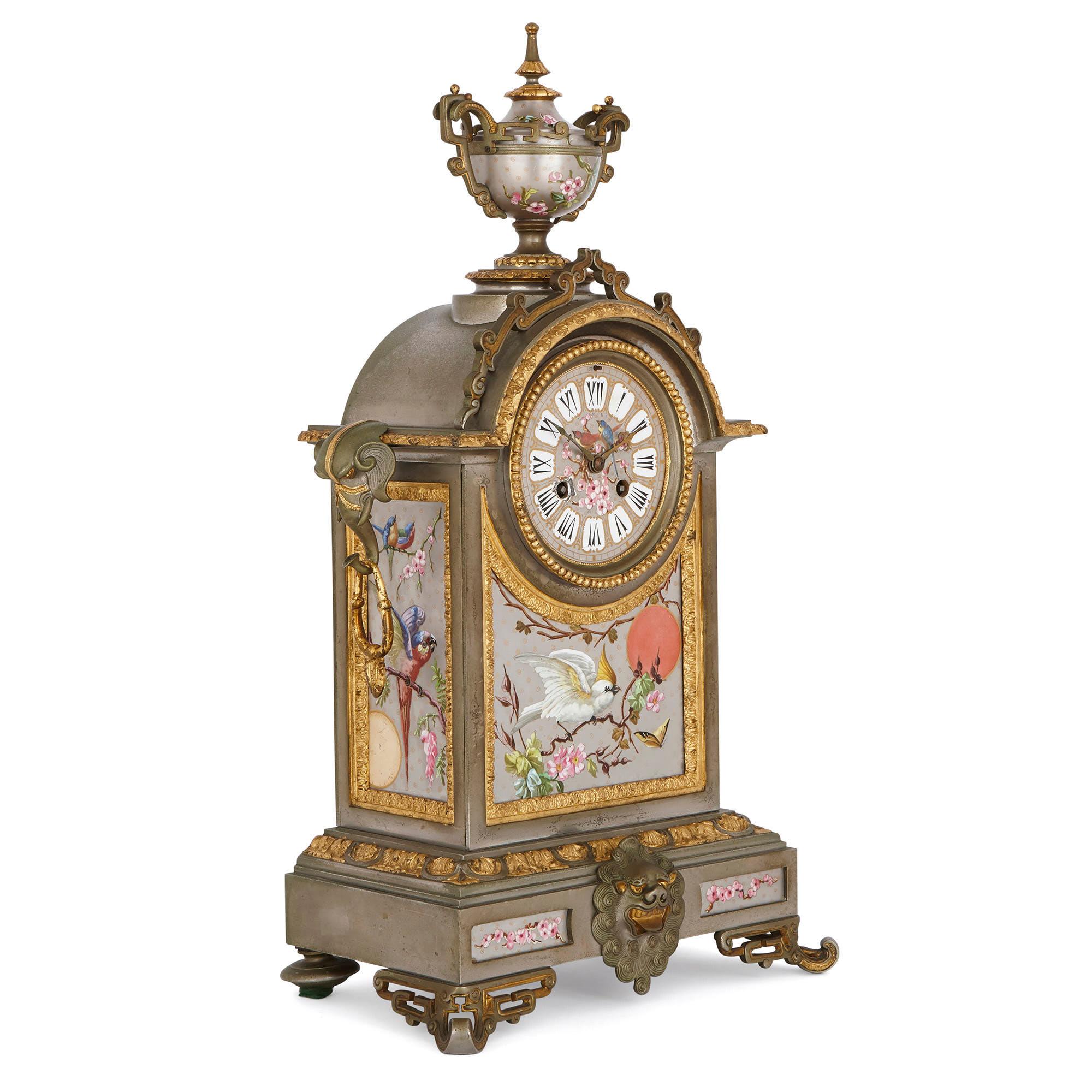 This wonderful clock set, which is comprised of a mantel clock and pair of flanking vases, is designed in a fanciful French ‘Oriental’ style. The set is crafted from brass which has been silvered, parcel gilt and painted. The clock is also mounted