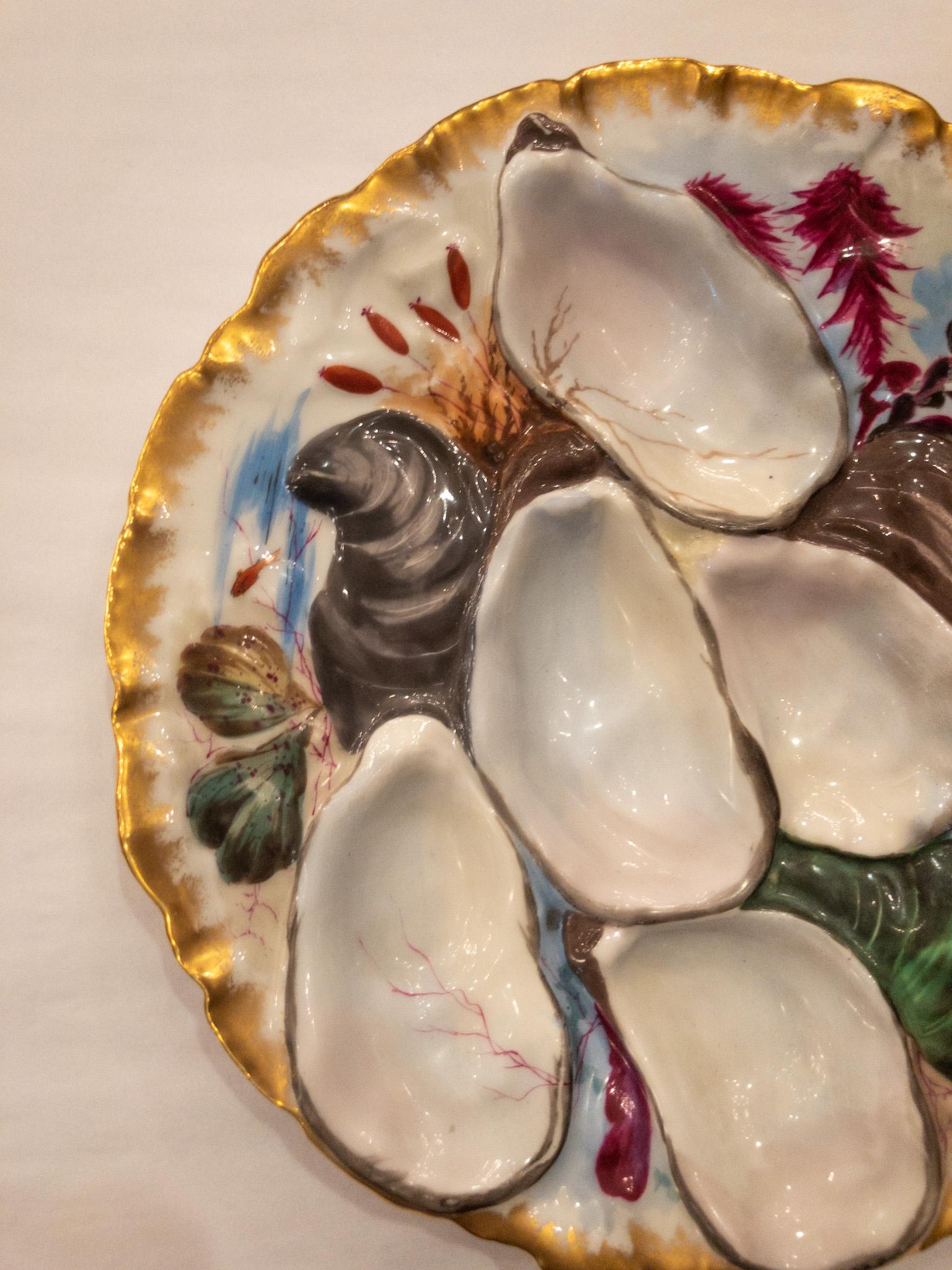 Antique French porcelain oyster plate signed Haviland Limoges Co. circa 1890 in turkey pattern with colorful hand painted details.