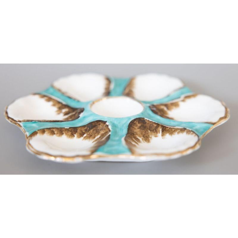 A gorgeous antique French porcelain oyster plate attributed to Limoges, circa 1900. This fine quality oyster plate has six wells and is hand painted in a beautiful blue green teal color with gilt details. It displays beautifully and would also be