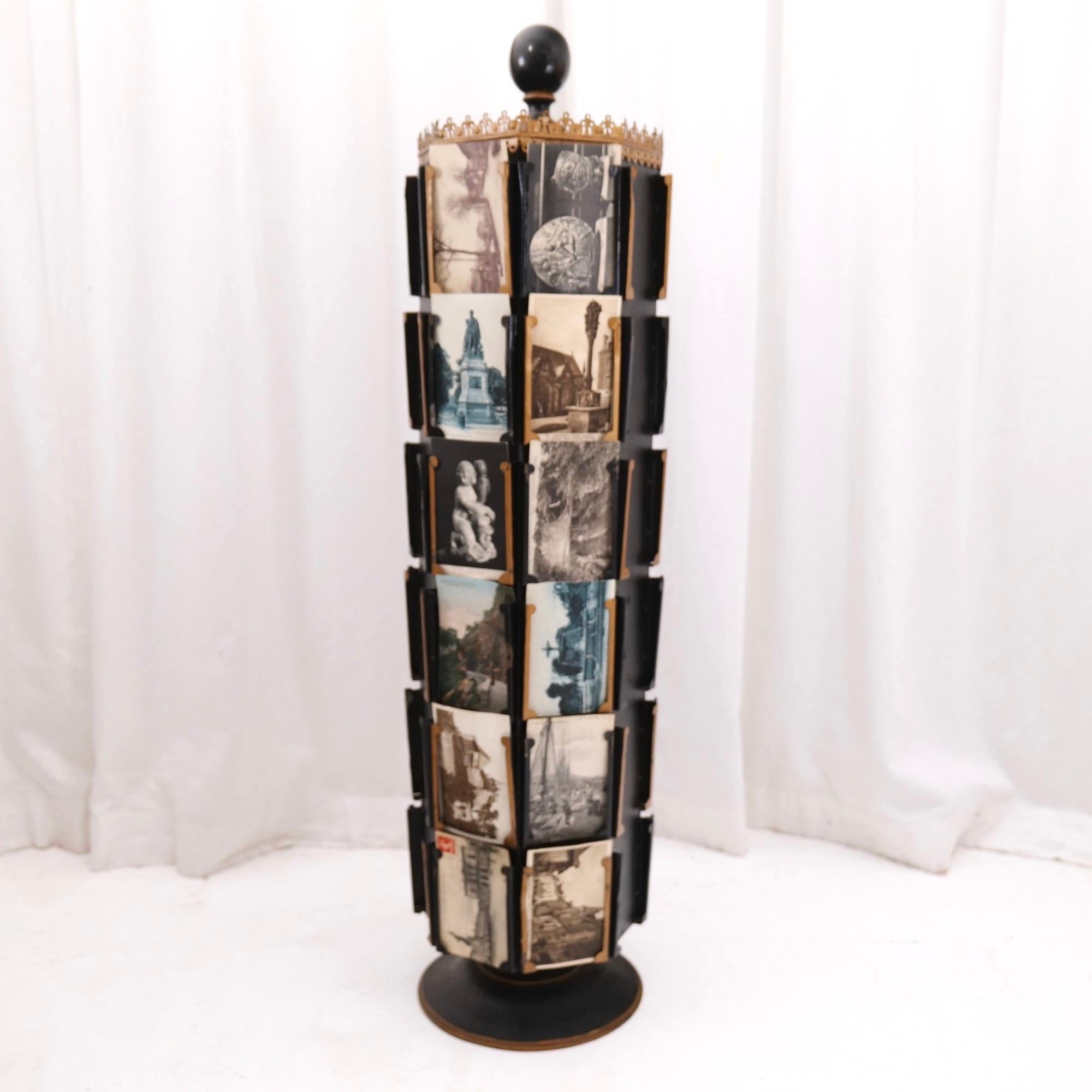 Very rare rotating postcard stand from wood and metall from france.

approx. 1910 - 1920 Paris - France

dimension:
102 cm heigh
24 cm diametre
7 cm x 14 cm postcard size

with signs of use and original patina. working