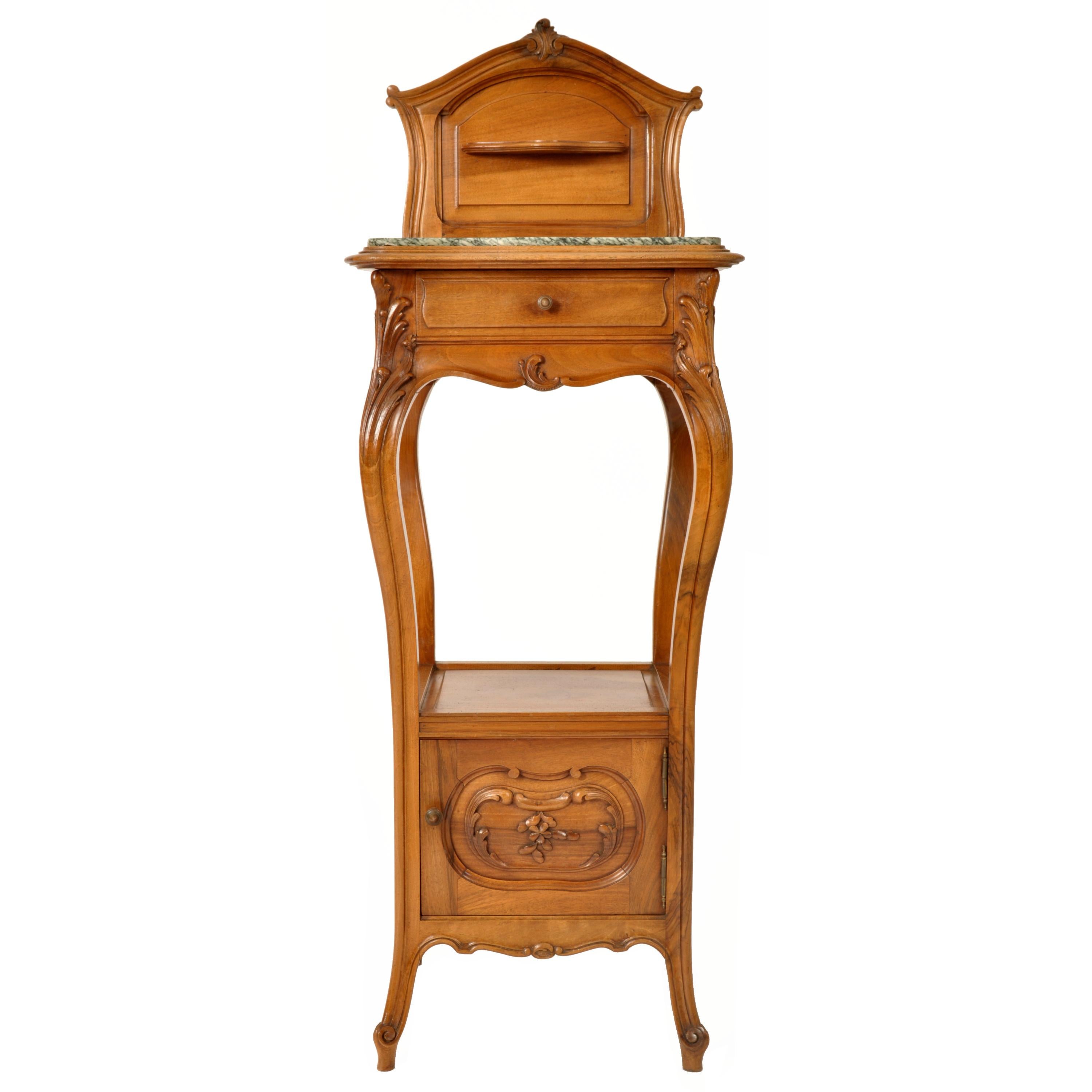 A very good antique walnut French Art Nouveau (in the Provincial manner), nightstand, side table, Circa 1900.
The stand having a carved backsplash with a small candle shelf, below is an inset variegated marble top, below this is a single drawer. The