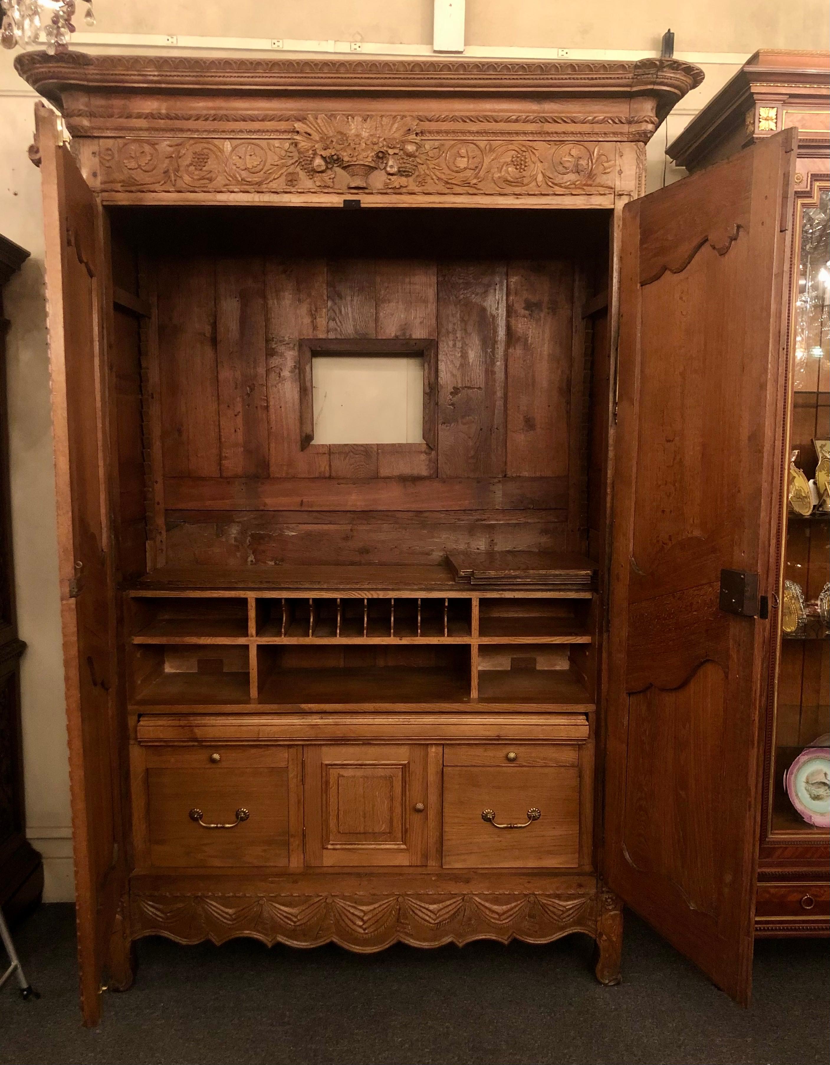 Antique French Provincial carved elm 2 door armoire with original brass hardware and fitted interior, Circa 1890's.