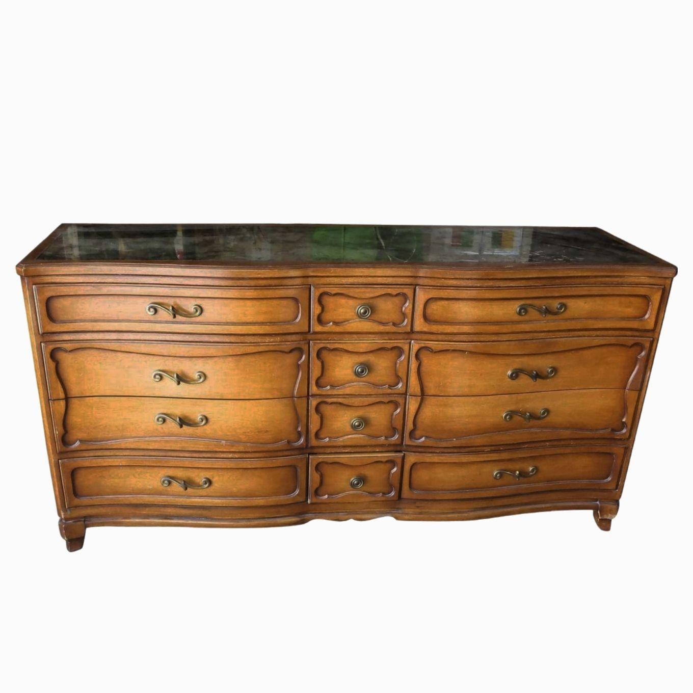 This beautifully restored rattan blending style vintage charm with modern comfort. Beautiful dresser console by reputable RWAY furniture featuring a mercury glass mirrored glass top with bronze pulls and twelve drawers. Solid wood and in good