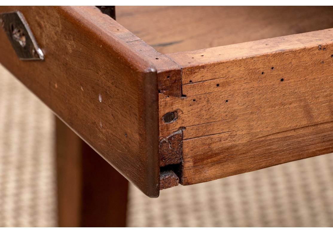 Retailed by Debordes, Paris. A finely crafted low table with a breadboard top, originally a Country French farm table that has had the height reduced.  With a single drawer on the apron on one side with a brass key escutcheon (lacking the key).
