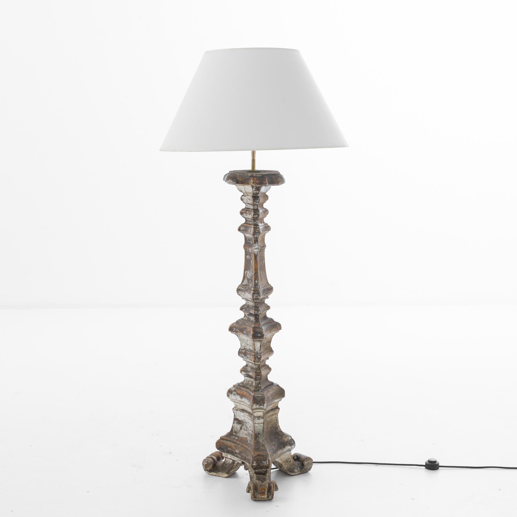 Made in France, circa 1800, this wooden floor lamp, with subtle carved ornament adorned with polychrome color, illuminates with a charming old-world ambiance. Formal carved profiles impart a neoclassical touch. The white empire lampshade, supported