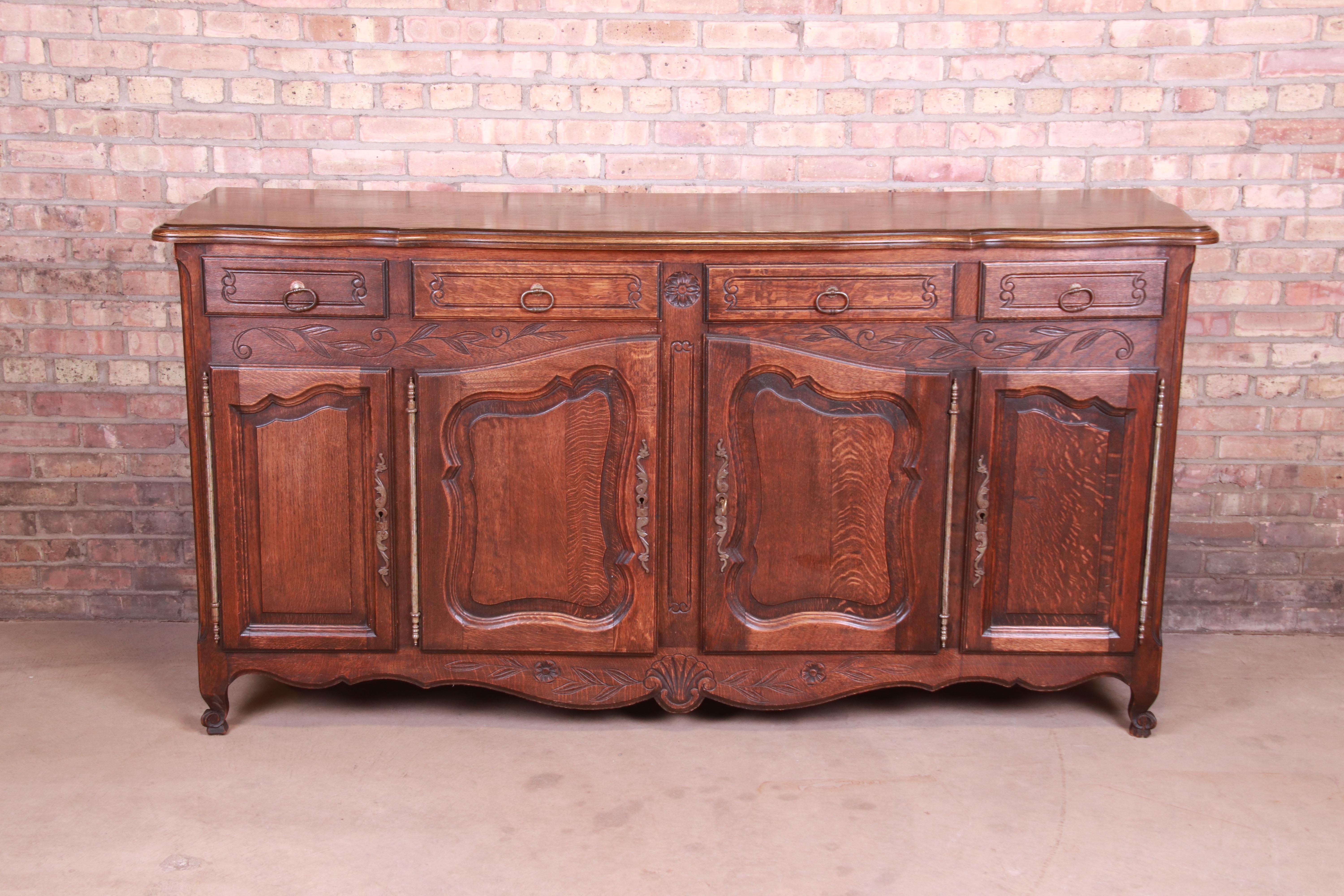 A gorgeous French Provincial Louis XV style sideboard, credenza, or bar cabinet

France, Circa 1900

Carved oak, with original brass hardware.

Measures: 79