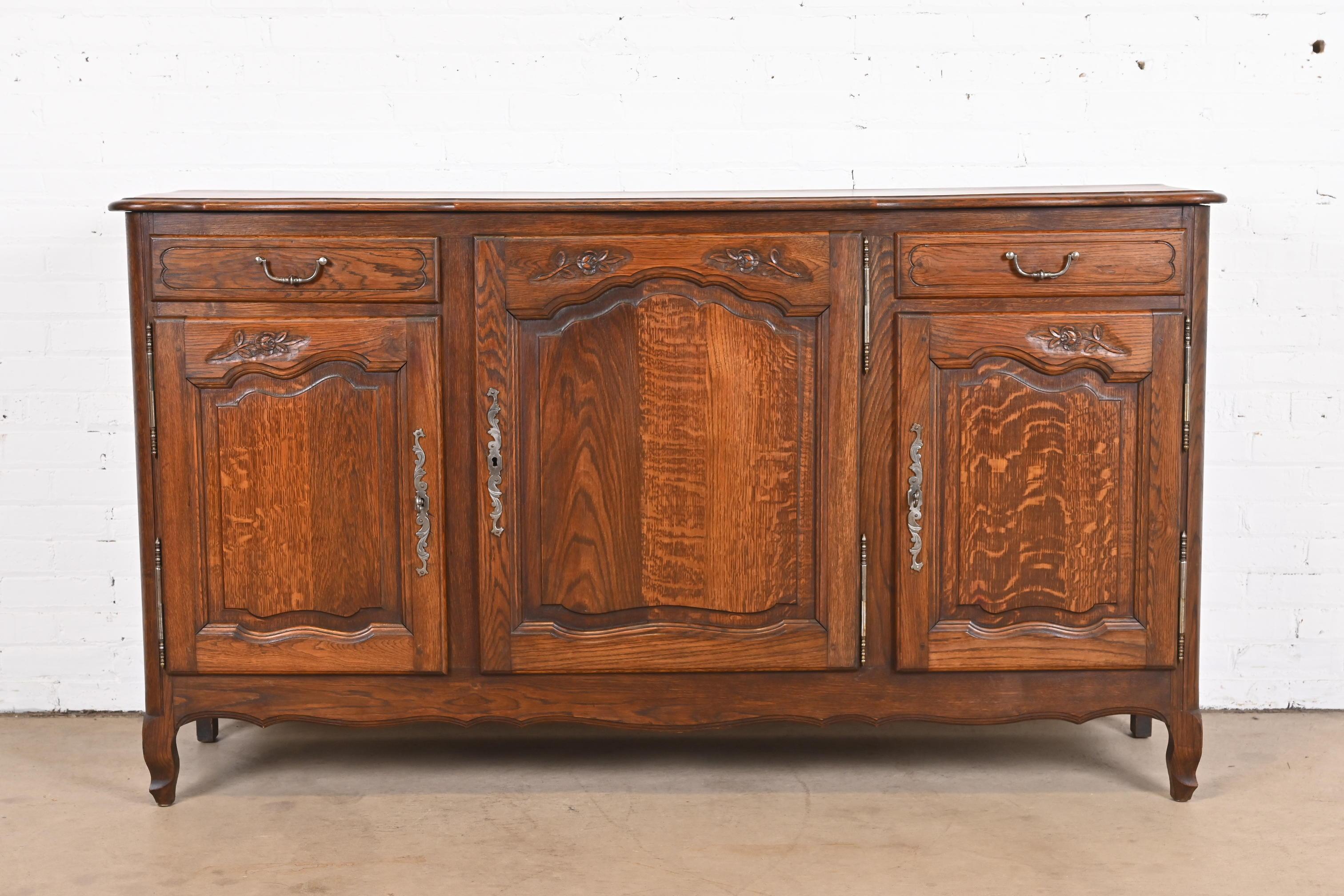 A gorgeous French Provincial Louis XV style sideboard, credenza, or bar cabinet

France, Early 20th Century

Carved oak, with original nickel hardware. Cabinets lock, and two keys are included.

Measures: 70.75