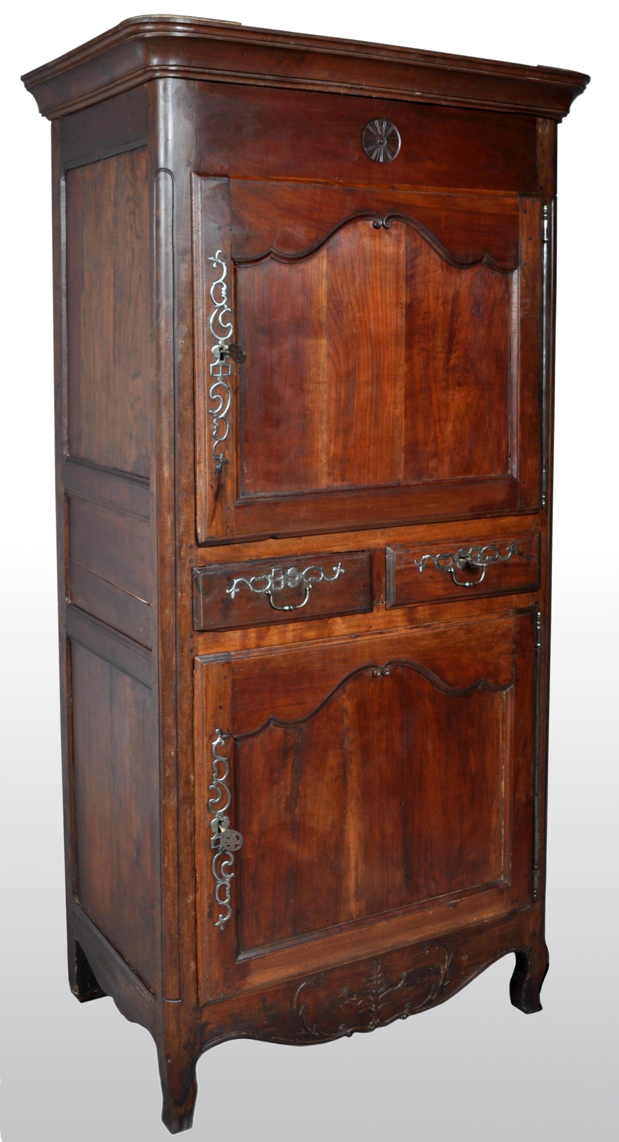 Antique French Provincial Louis XV fruitwood Bonnetiere / armoire / cabinet, circa 1770. The cabinet having a removable stepped cornice with a pair of paneled doors below and intersected to the middle by a pair of drawers. The cabinet having the