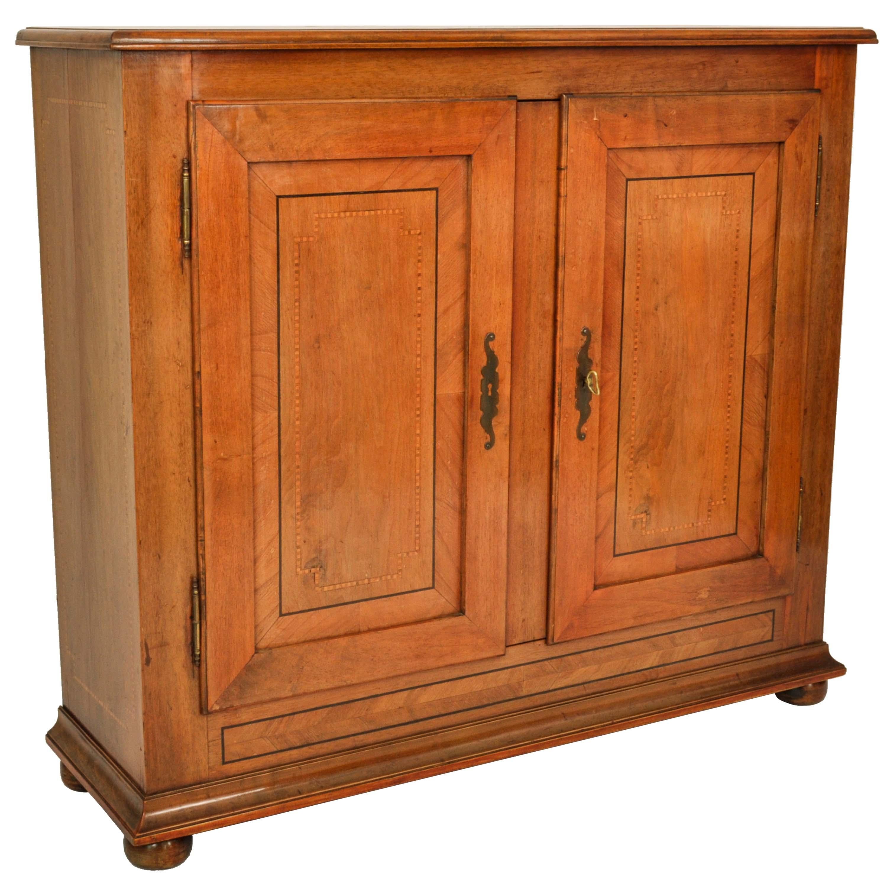 A handsome antique French Provincial inlaid cherry, Louis XV buffet, side cabinet, circa 1820.
The twin door cabinet of a very usable size and having chevron shaped inlaid bands on both the sides and the front of the cabinet. 
The twin fielded panel