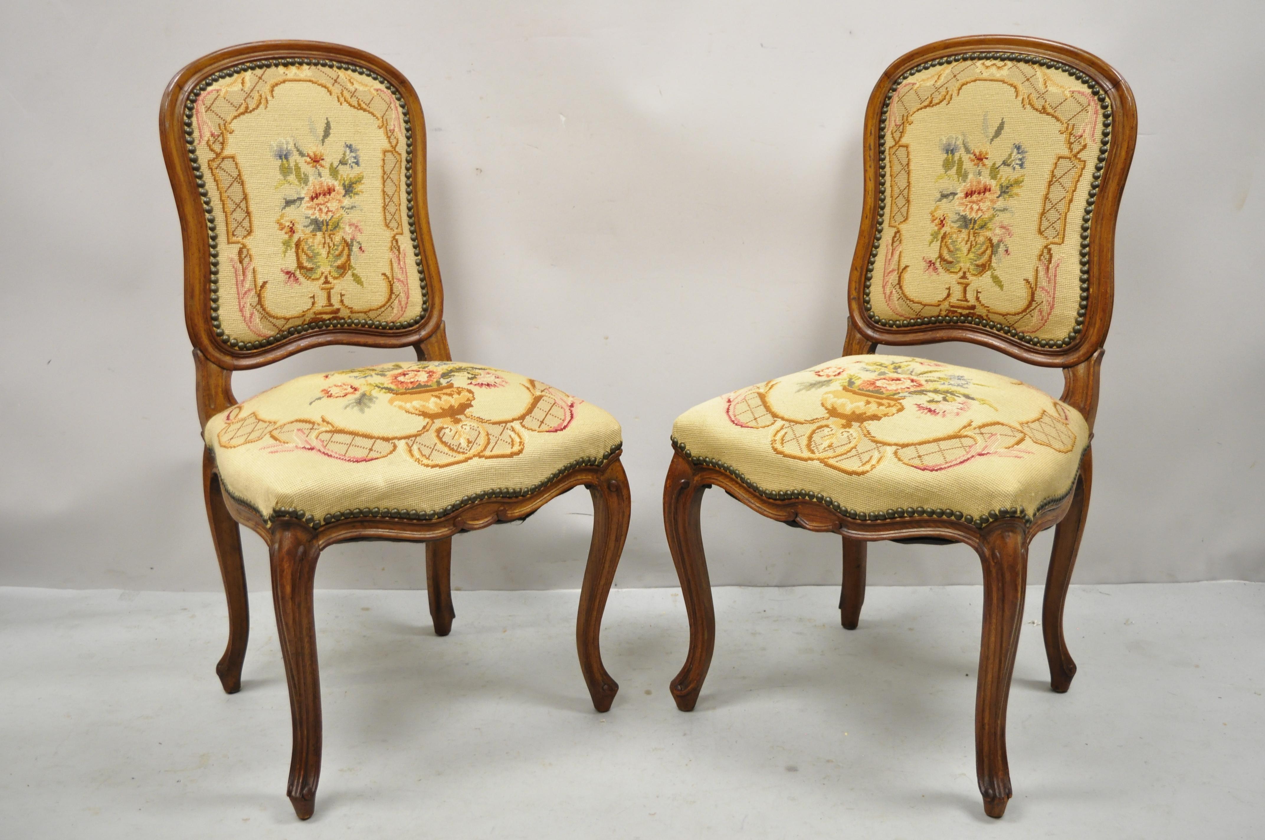 Antique French Provincial Louis XV carved walnut floral needlepoint side chairs - a Pair. Item features needlepoint upholstered back and seat, shaped backs, solid wood frame, beautiful wood grain, nicely carved details, cabriole legs, very nice
