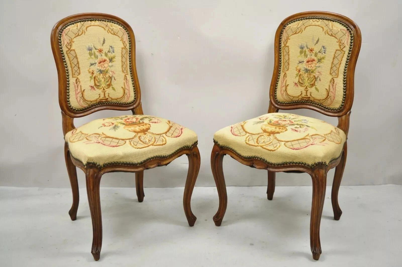 Antique French Provincial Louis XV Style Walnut Floral Needlepoint Side Chairs - a Pair. Item features needlepoint upholstered back and seat, shaped backs, solid wood frame, beautiful wood grain, nicely carved details, cabriole legs, very nice