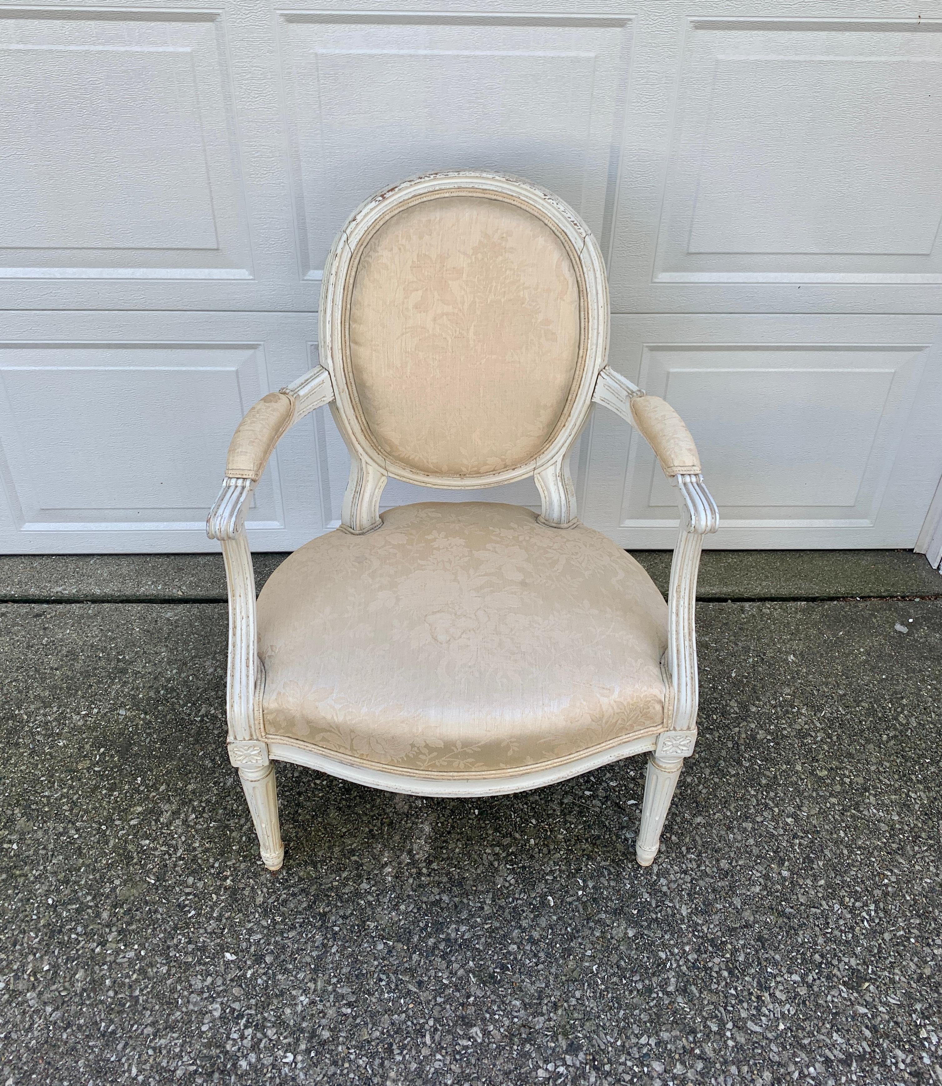 A stunning French Provincial Louis XVI style armchair

France, Circa 1920s

Carved painted wood frame, with cream damask patterned upholstery

Measures: 23.25