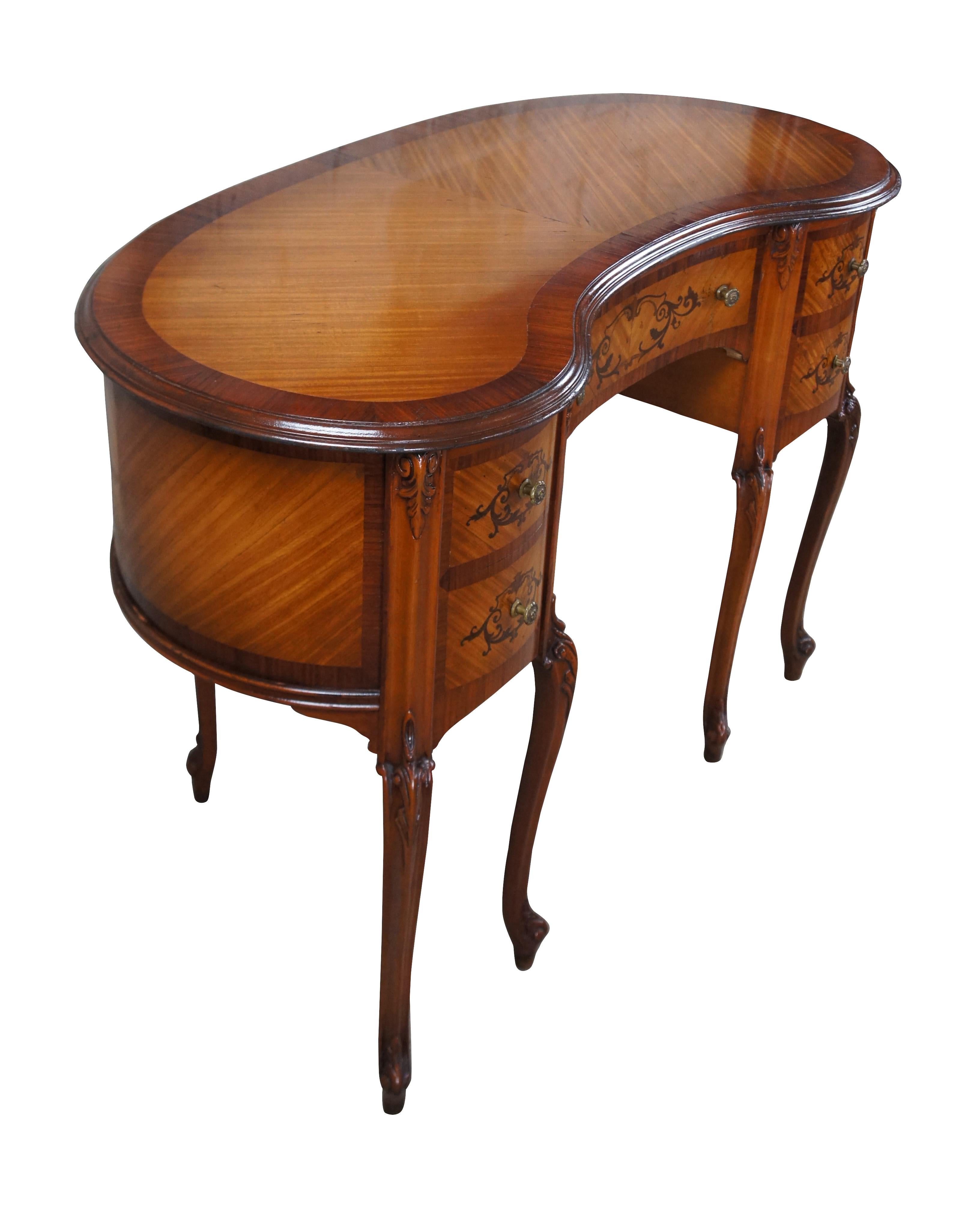 Antique French Provincial / Louis XV kidney bean kneehole writing or vanity desk.  Made of mahogany and fruit wood featuring inlaid parquetry design with scrolled floral and acanthus theme.

Dimensions:
43